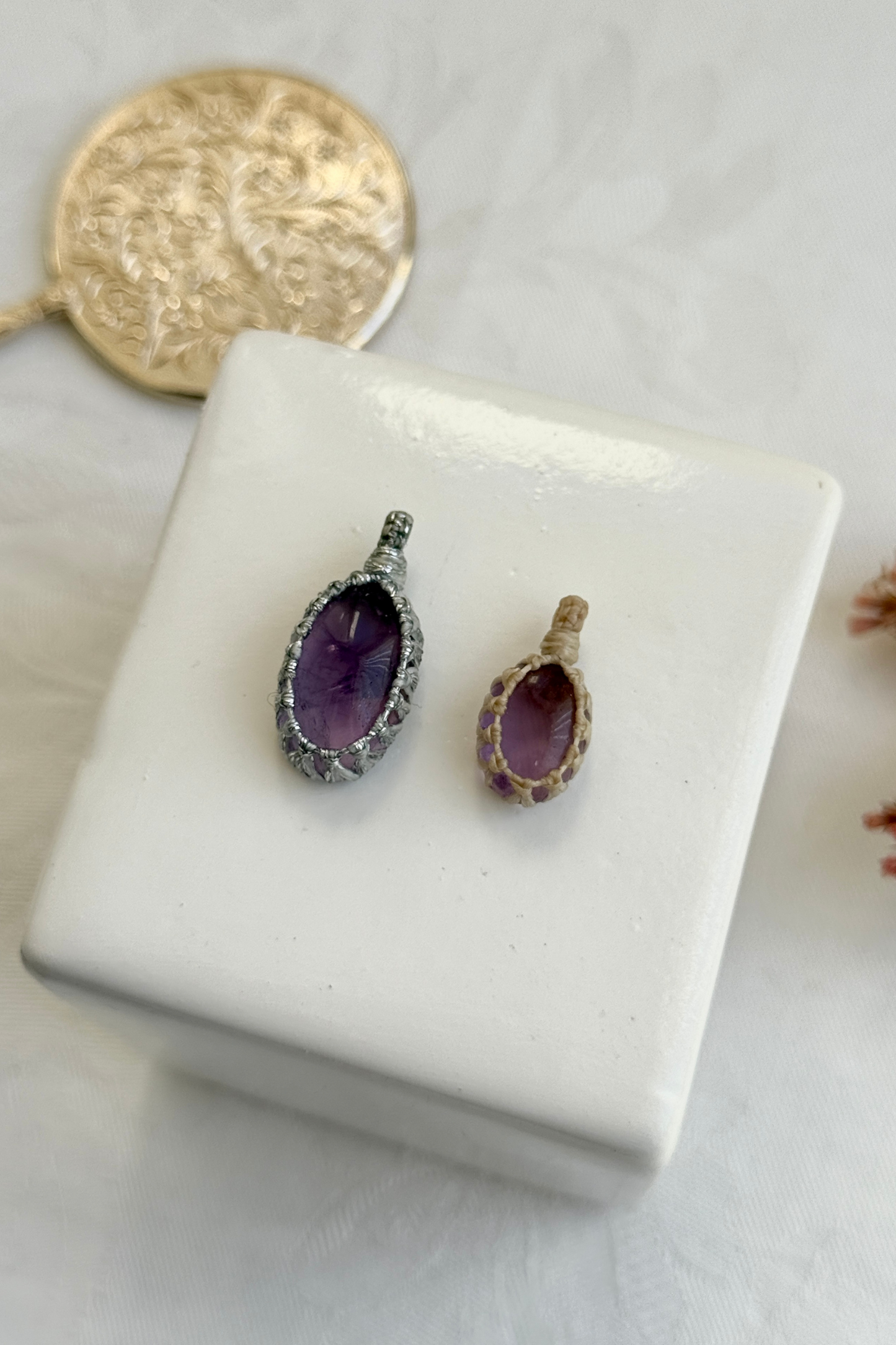 Close-up view of handmade Candy Charms with natural Amethyst gemstone pendants, showcasing the macrame wrapping and unique stone details.