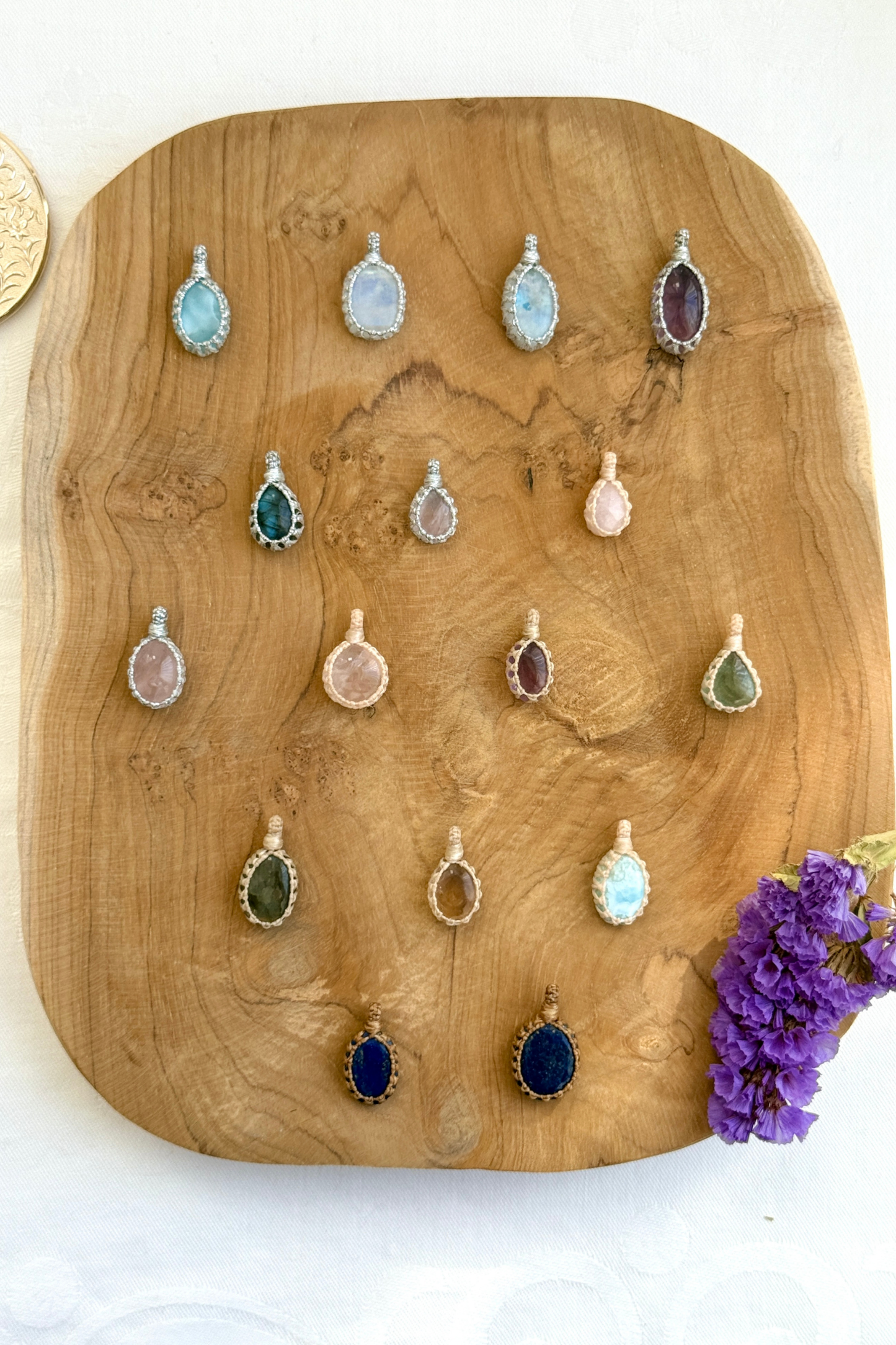 Full collection of handmade Candy Charms – natural gemstone pendants wrapped in macrame, showcasing various gemstones and charm designs.