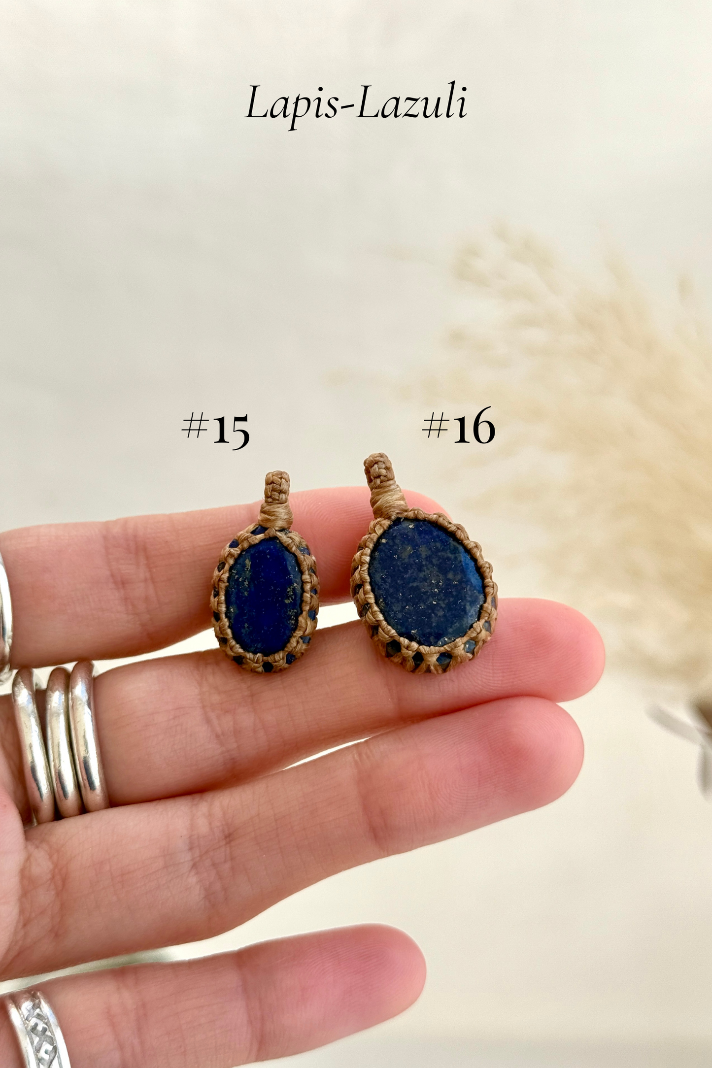Close-up of Candy Charms featuring Lpis Lazuli pendants held in hand, showing the size of the charm and detailed gemstone features.
