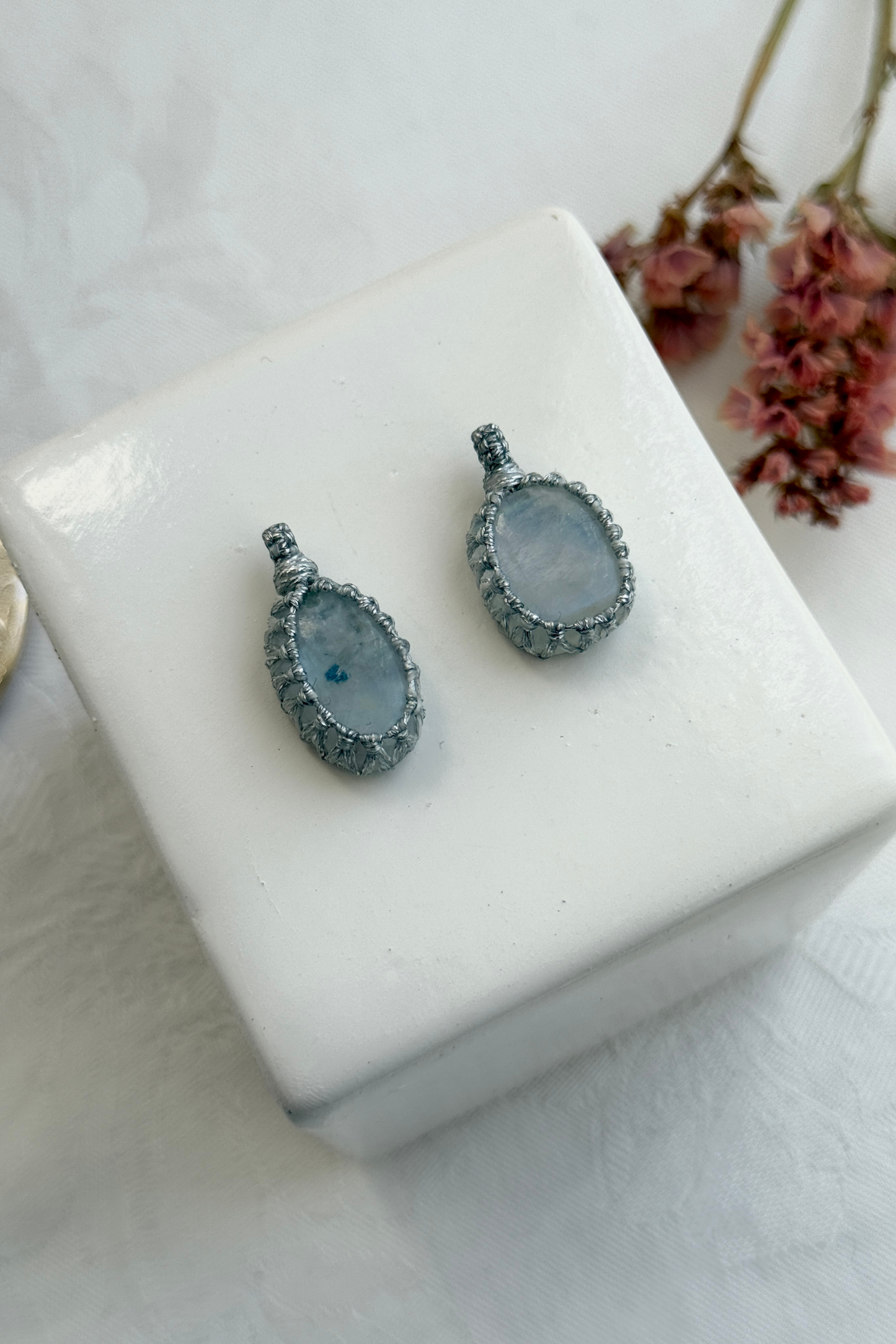 Close-up view of handmade Candy Charms with natural Moonstone gemstone pendants, showcasing the macrame wrapping and unique stone details.