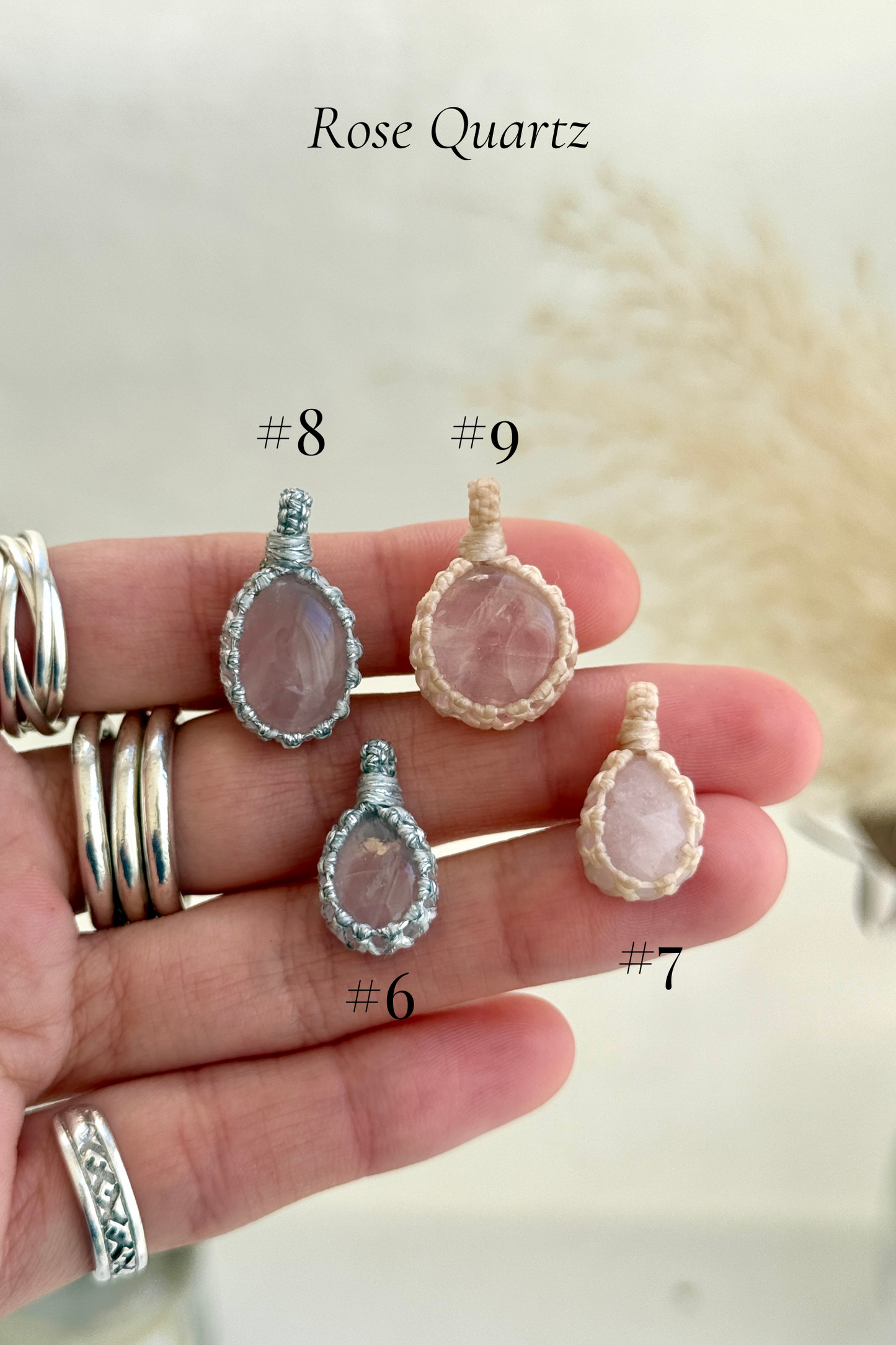 Close-up of Candy Charms featuring Rose Quartz pendants held in hand, showing the size of the charm and detailed gemstone features.