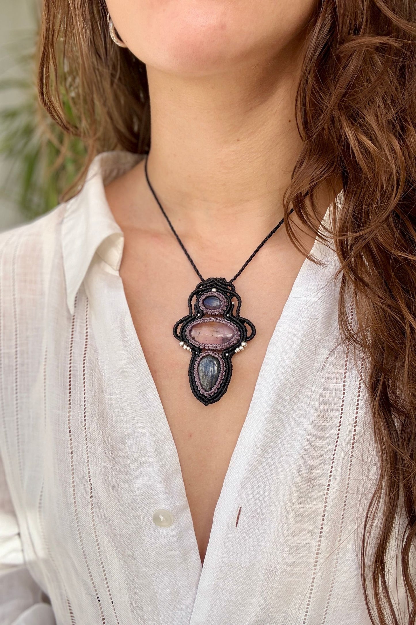 Amethyst, Ametrine and Silver Sheen Obsidian macrame necklace worn by a model. Showcasing the unique handmade design and how it looks when worn.