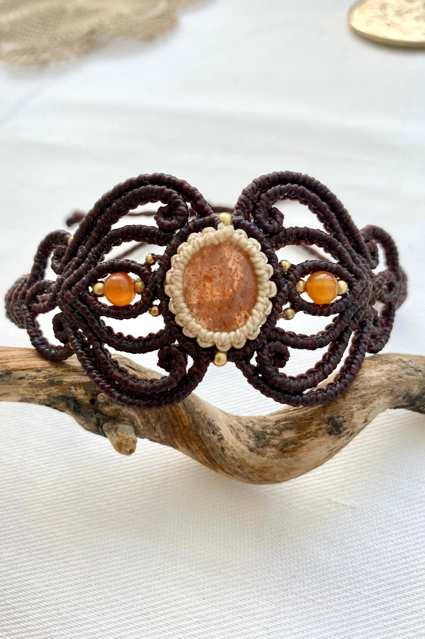 Centered view of the handmade bracelet, showing off the central Sunstone gemstone and carnelian accents, designed for a perfect blend of elegance and comfort