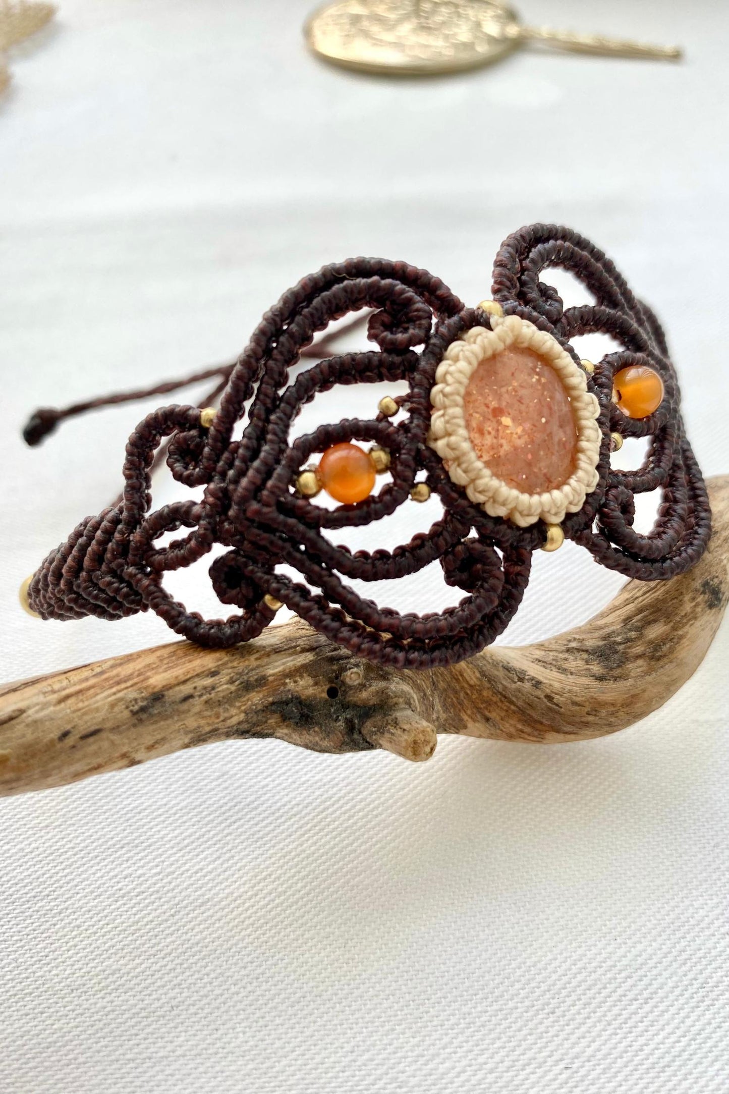 Alternate side view of the handmade bracelet, highlighting the unique design of the central gemstone and carnelian accents, with the adjustable closure for a customizable fit.