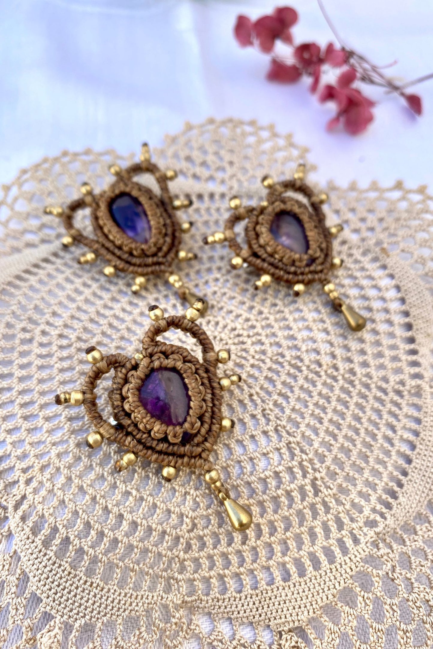 Detailed view of the Cupid Amethyst Brooches with gold accents, highlighting the heart-shaped macrame craftsmanship and deep purple amethyst gemstones.