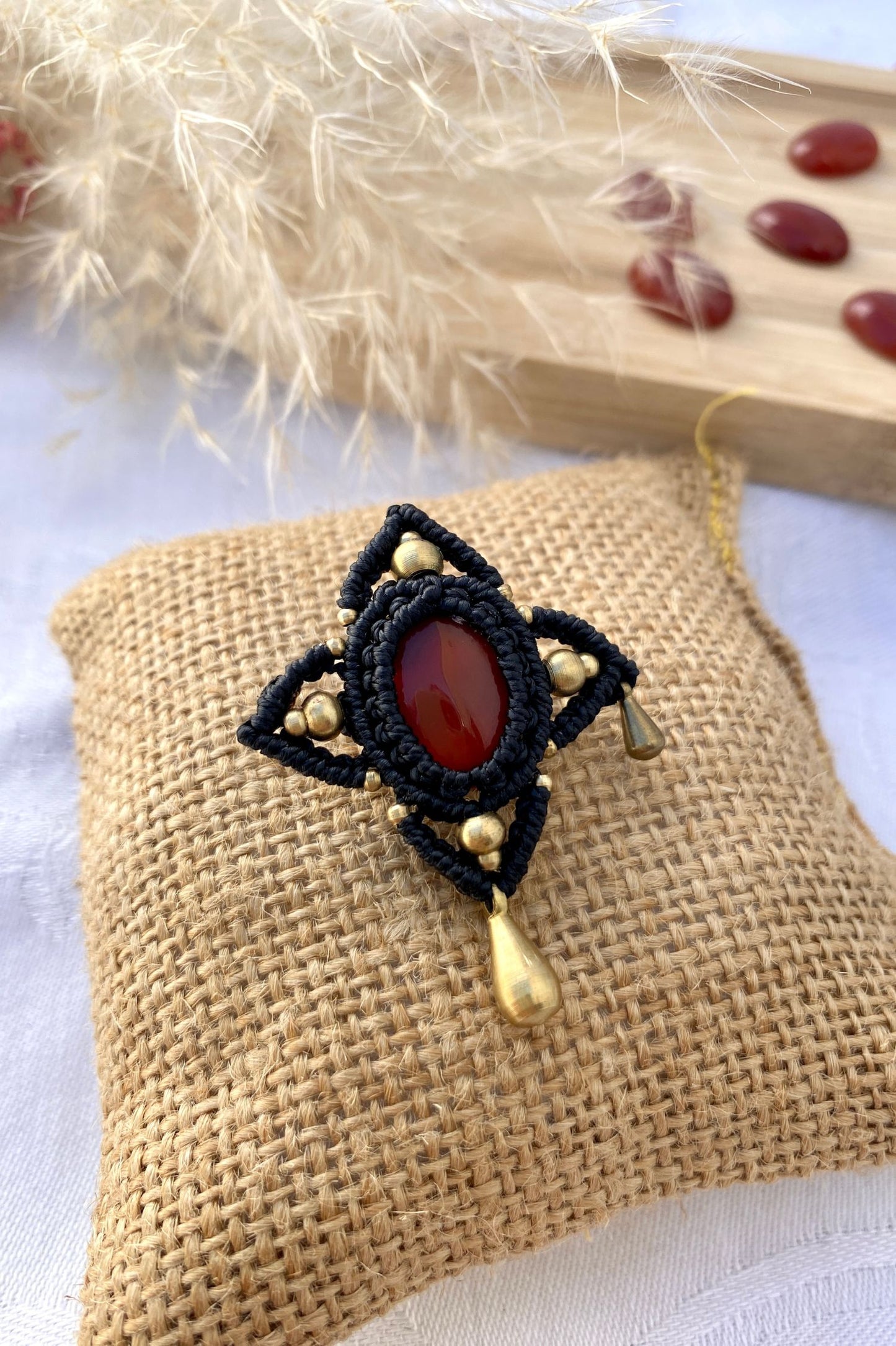 Artistic statement brooch featuring a stunning Carnelian, laid out to highlight its intricate design and high-quality craftsmanship.