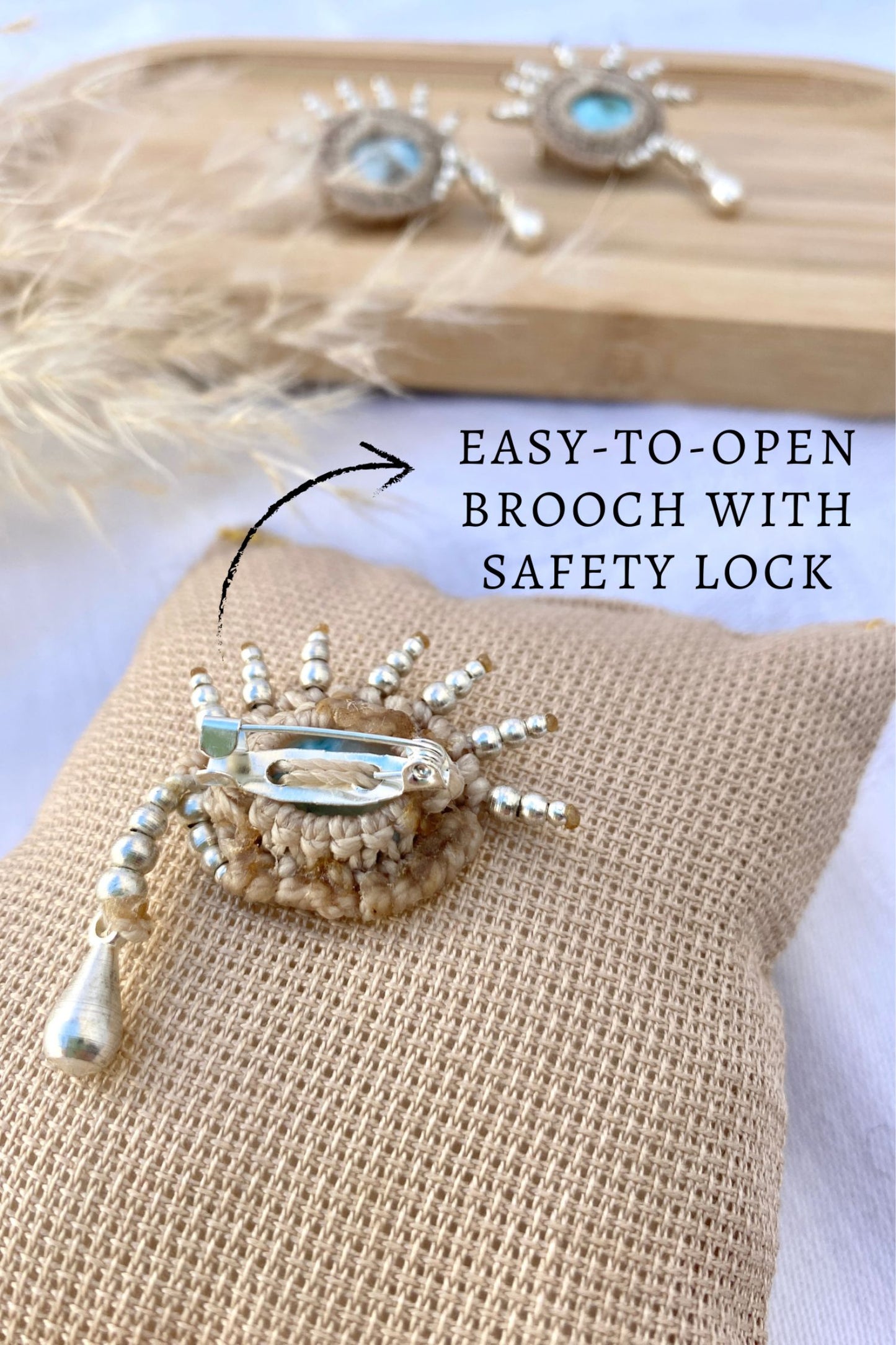 Detailed view of the brooch’s secure safety lock closure, designed for easy wear and durability.