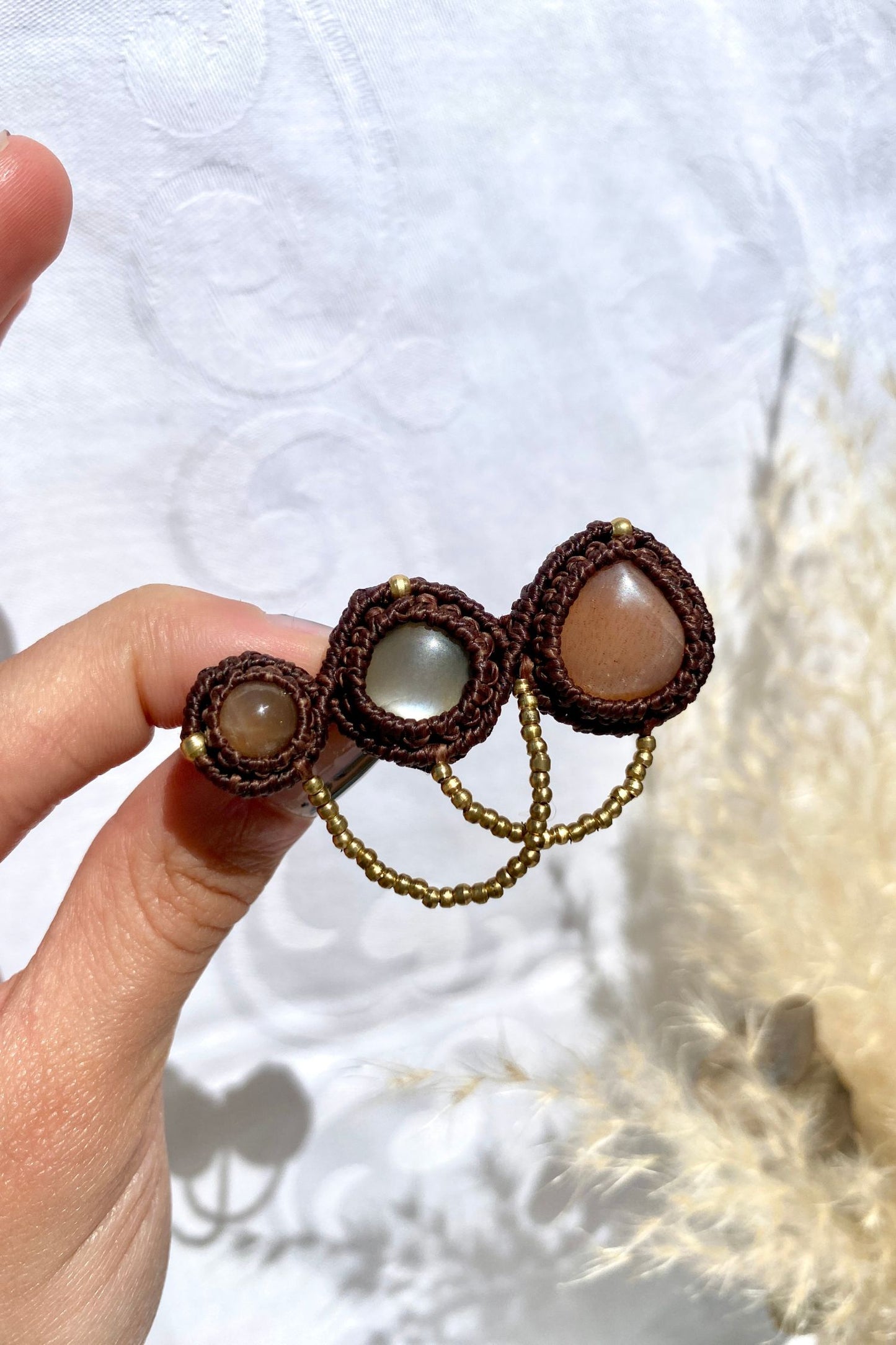 Handmade statement brooch featuring three shimmery Peach Moonstone gemstones, crafted with a unique and artistic design. A bold yet elegant accessory for any outfit.