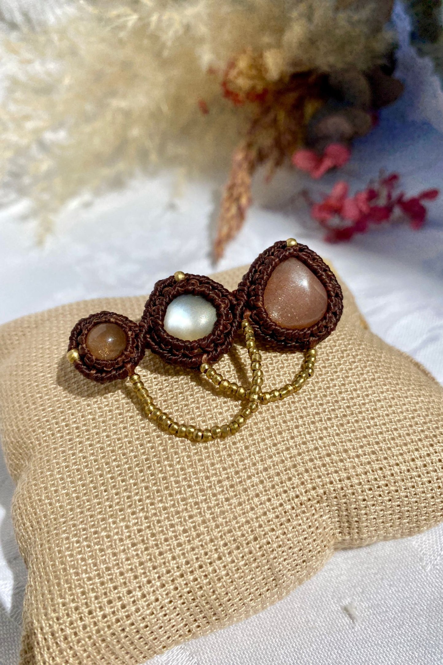 Artistic statement brooch featuring three Peach Moonstones, laid out to highlight its intricate design and high-quality craftsmanship.