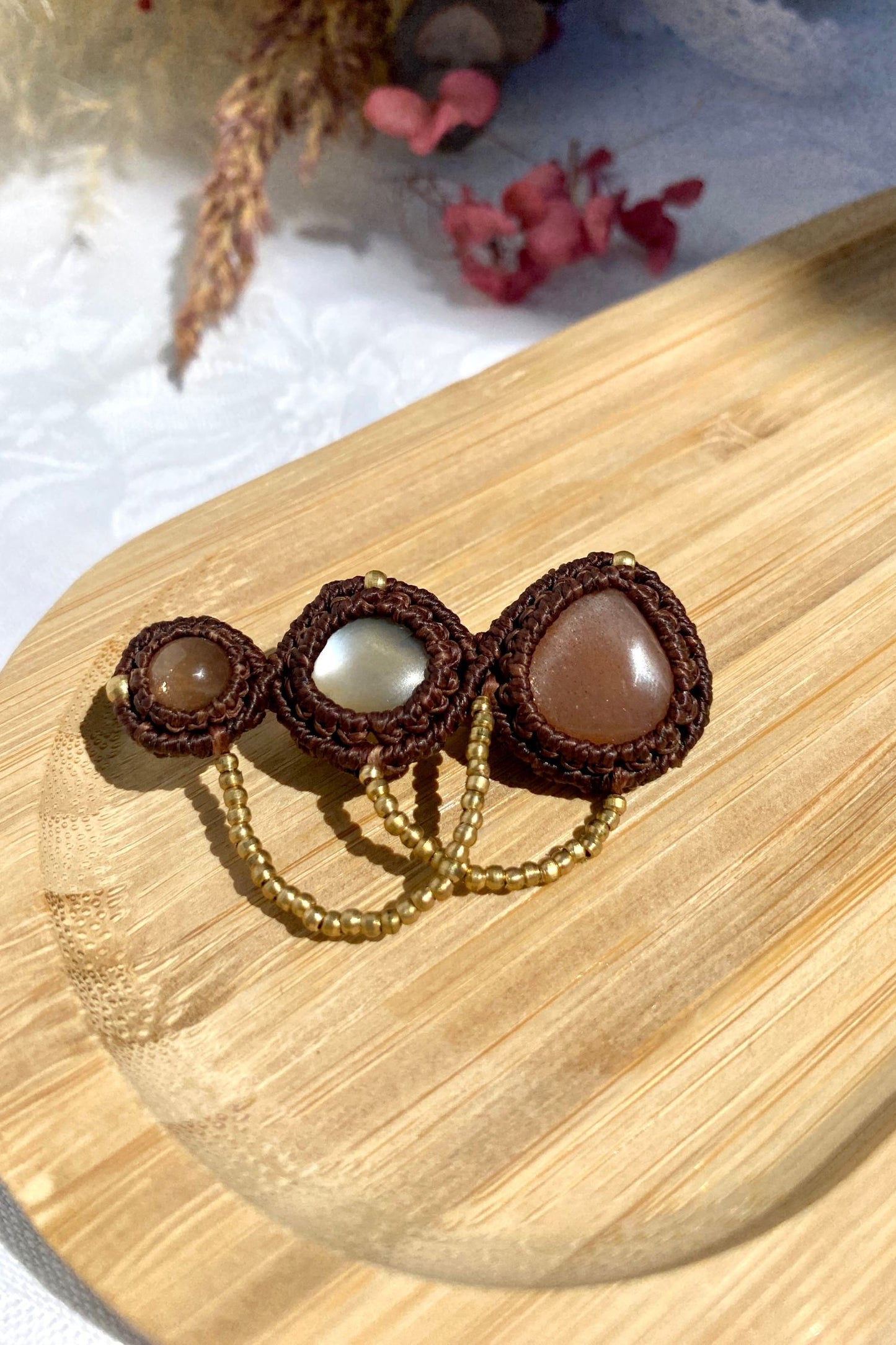 Handmade Peach Moonstone brooch displayed from a different angle, showcasing the details of the shimmering gemstones and unique structure.