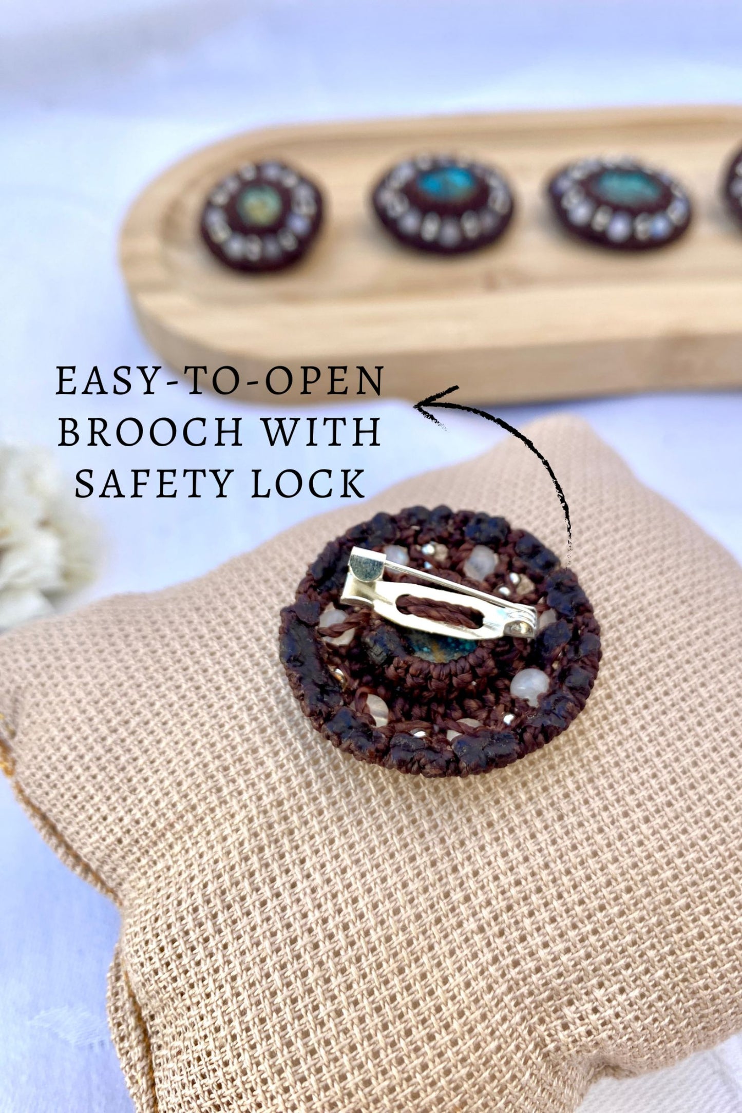 Back view of the handmade turquoise brooch, showing the secure safety lock closure for easy wear and a firm hold.