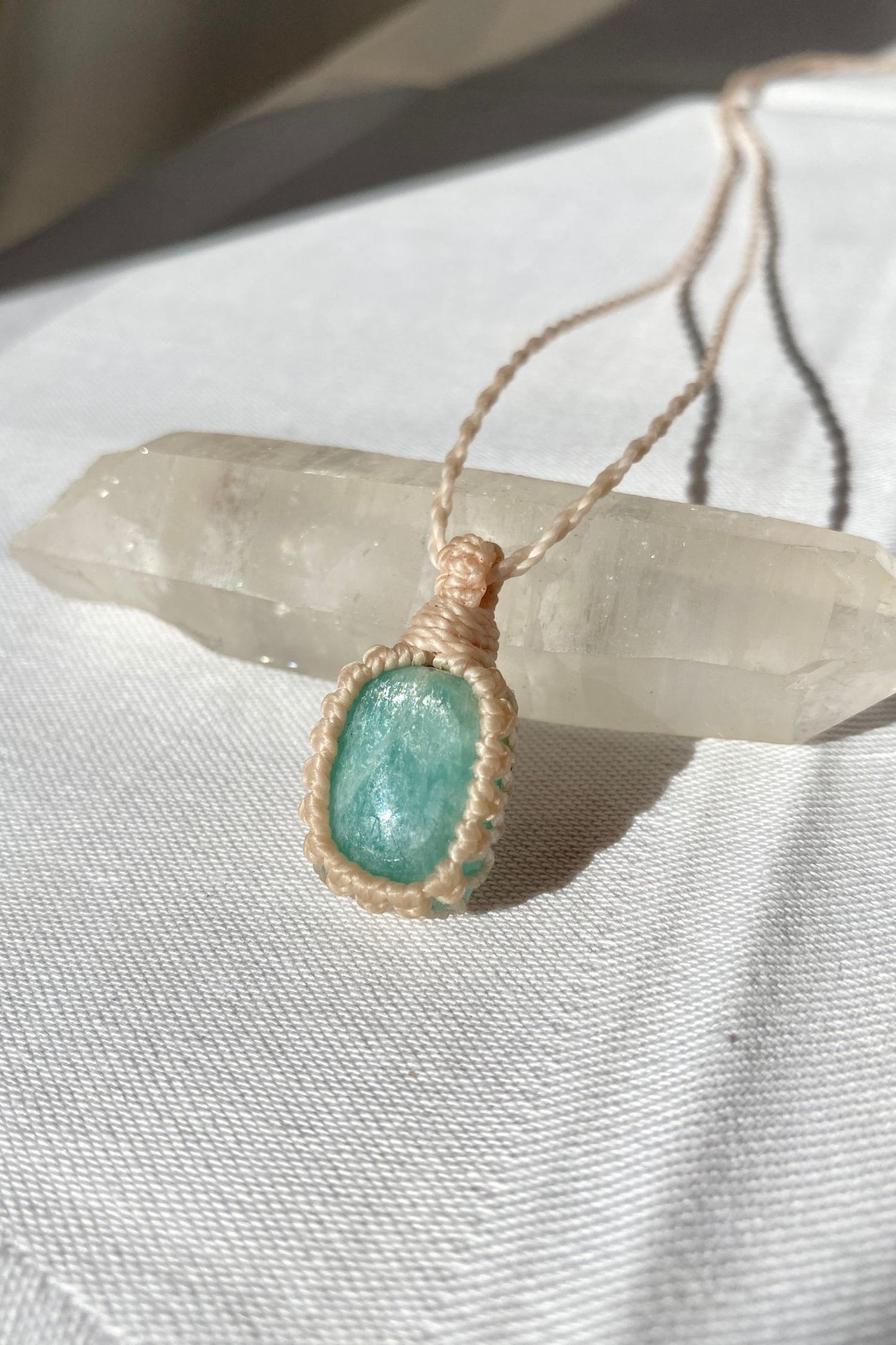 Close-up of handmade Amazonite Macrame necklace, showcasing the intricate macrame knotting and the vibrant blue hues of the gemstone.