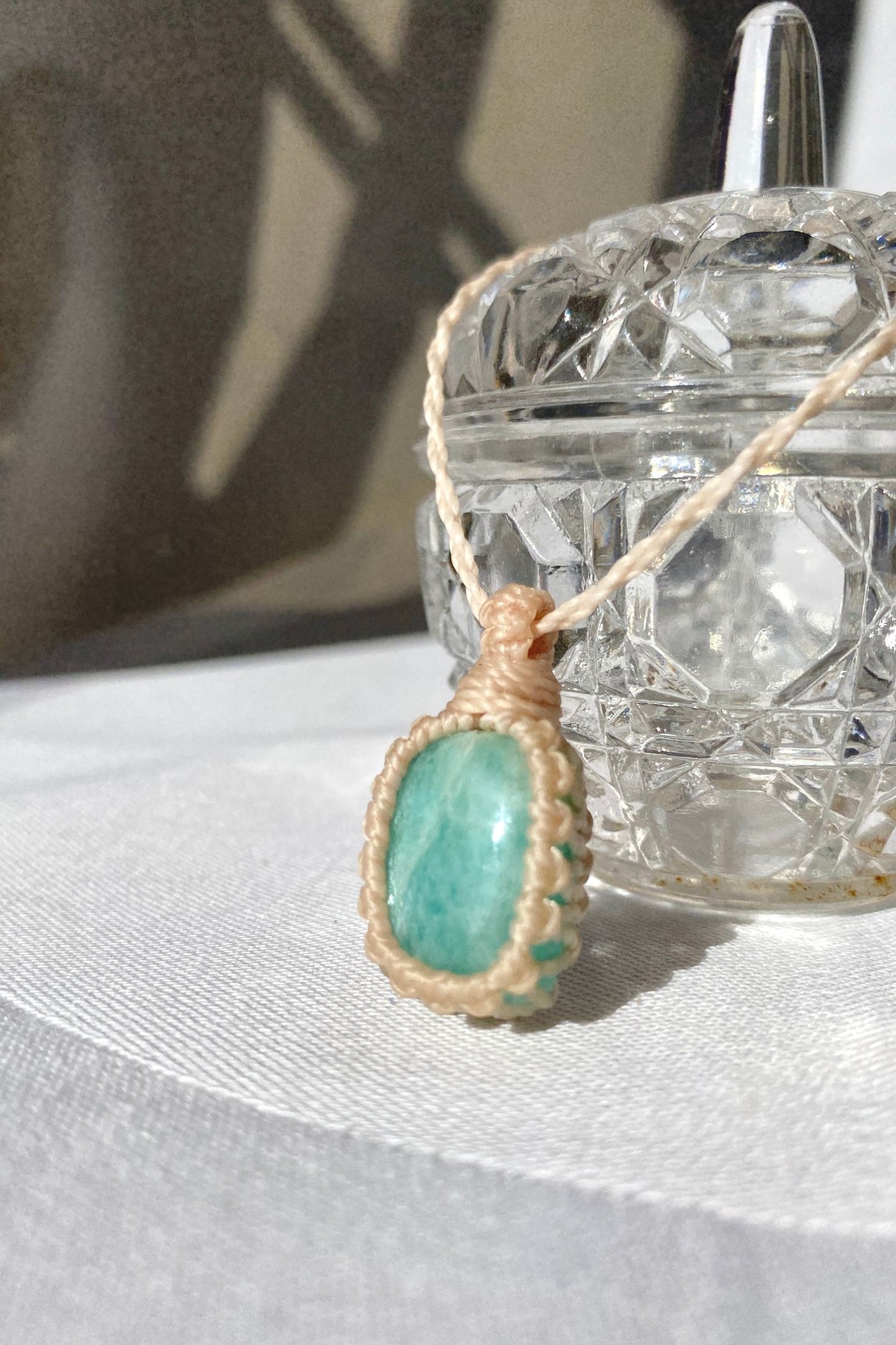 Handmade Amazonite Macrame necklace displayed standing, highlighting the minimalist macrame design and the natural beauty of the blue gemstone.