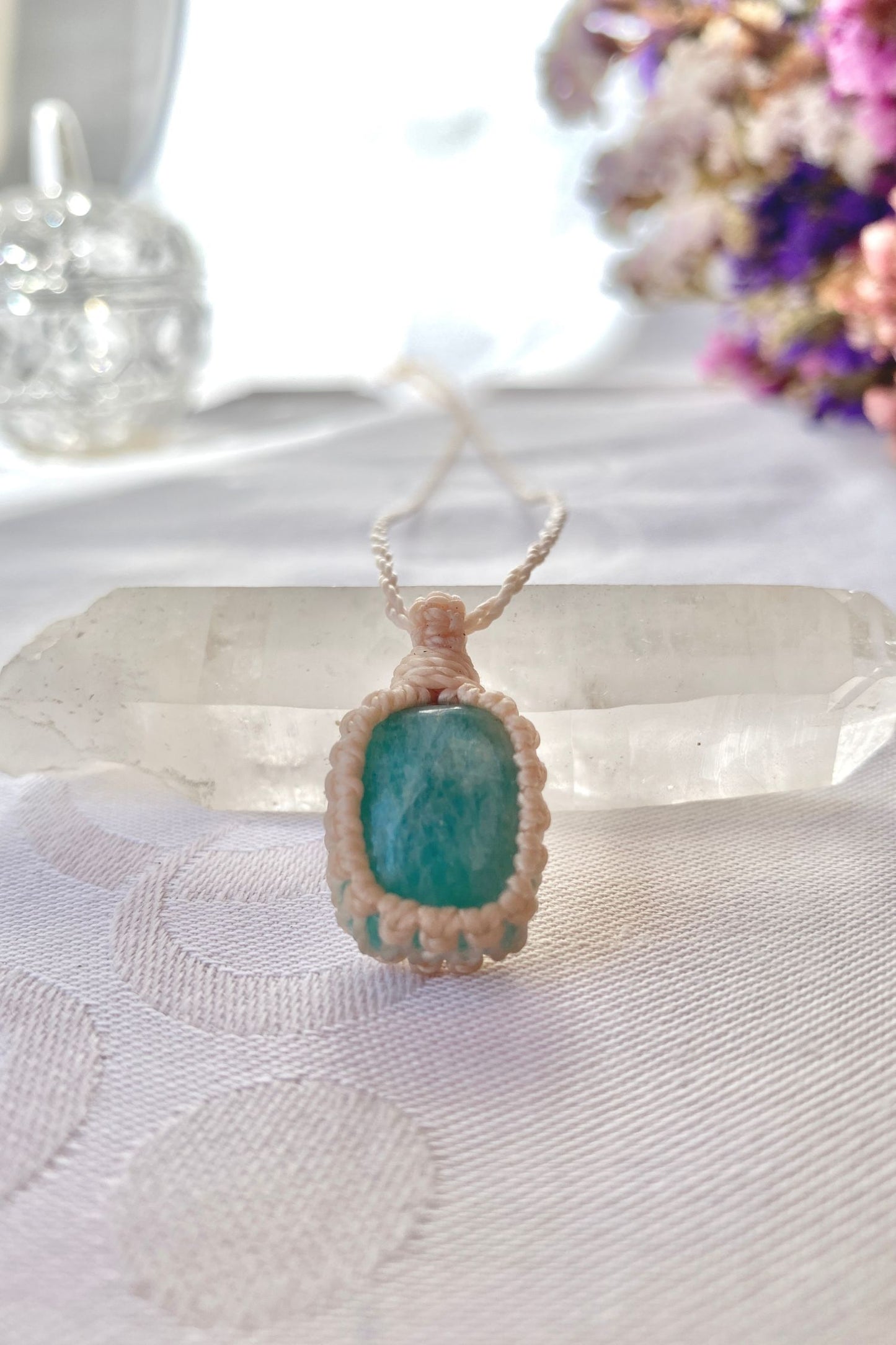 Close-up of the Amazonite Macrame necklace, showing the fine macrame details and the unique blue gemstone centerpiece.