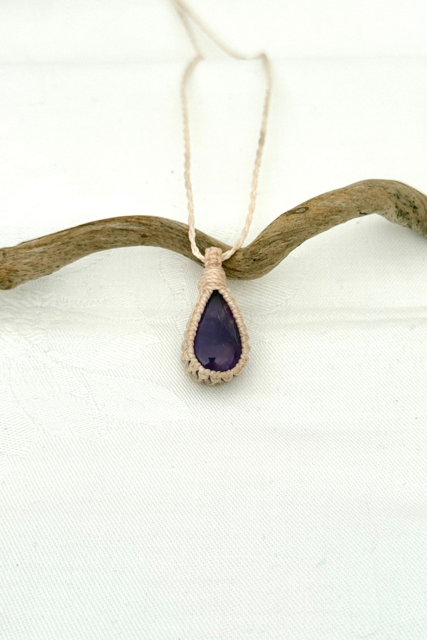 Handmade Amethyst Macrame necklace featuring a high-quality gemstone, laid flat to showcase its delicate everyday-wear design from the Essence collection.