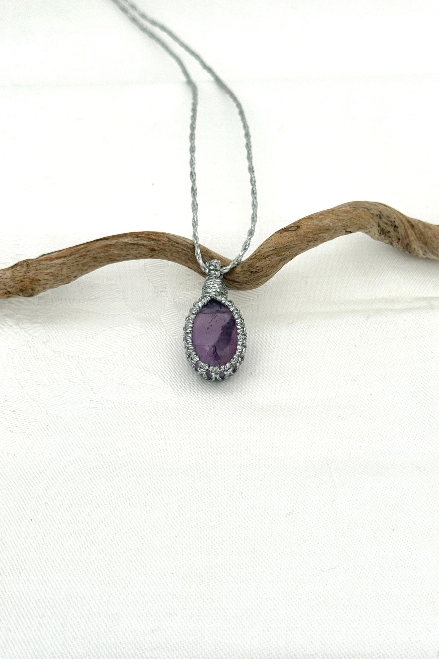 Handmade Amethyst Macrame necklace featuring a high-quality gemstone, laid flat to showcase its delicate everyday-wear design from the Essence collection.