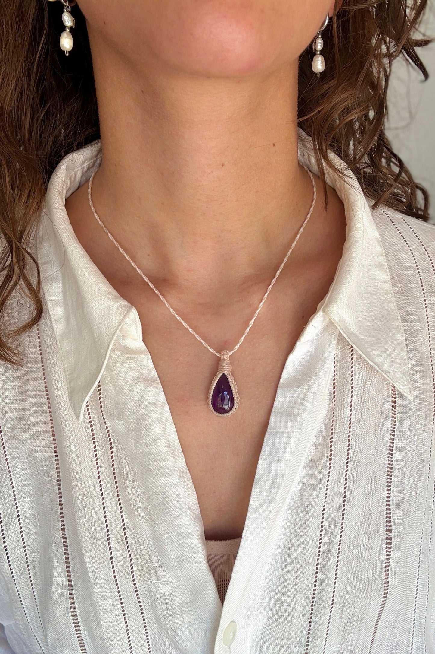 Model wearing a delicate handmade Amethyst macrame necklace with a beige cord, perfect for everyday wear.