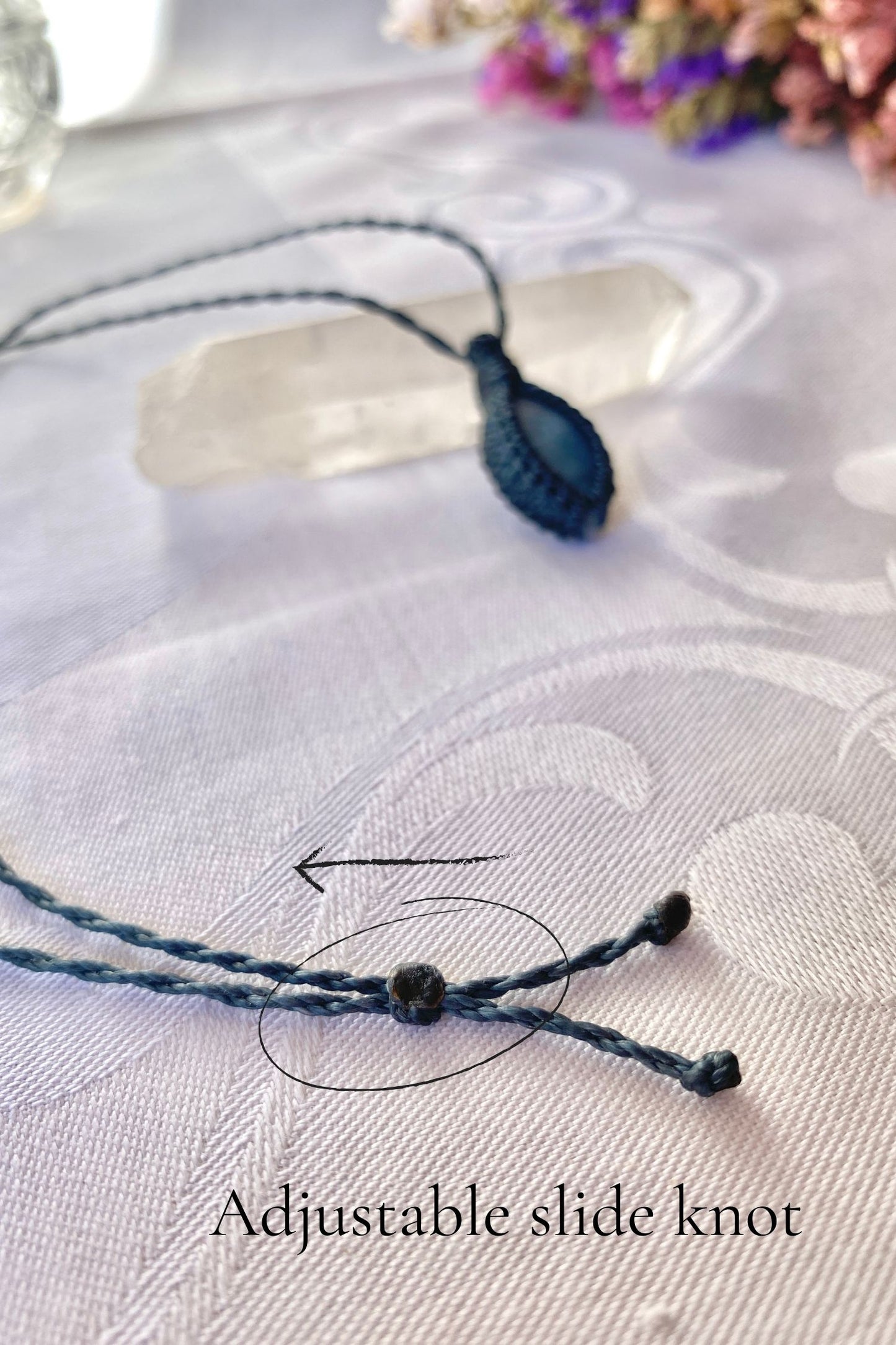 Close-up of the adjustable sliding knot on the Aquamarine Macrame necklace, allowing for an easy and customizable fit for any wearer.