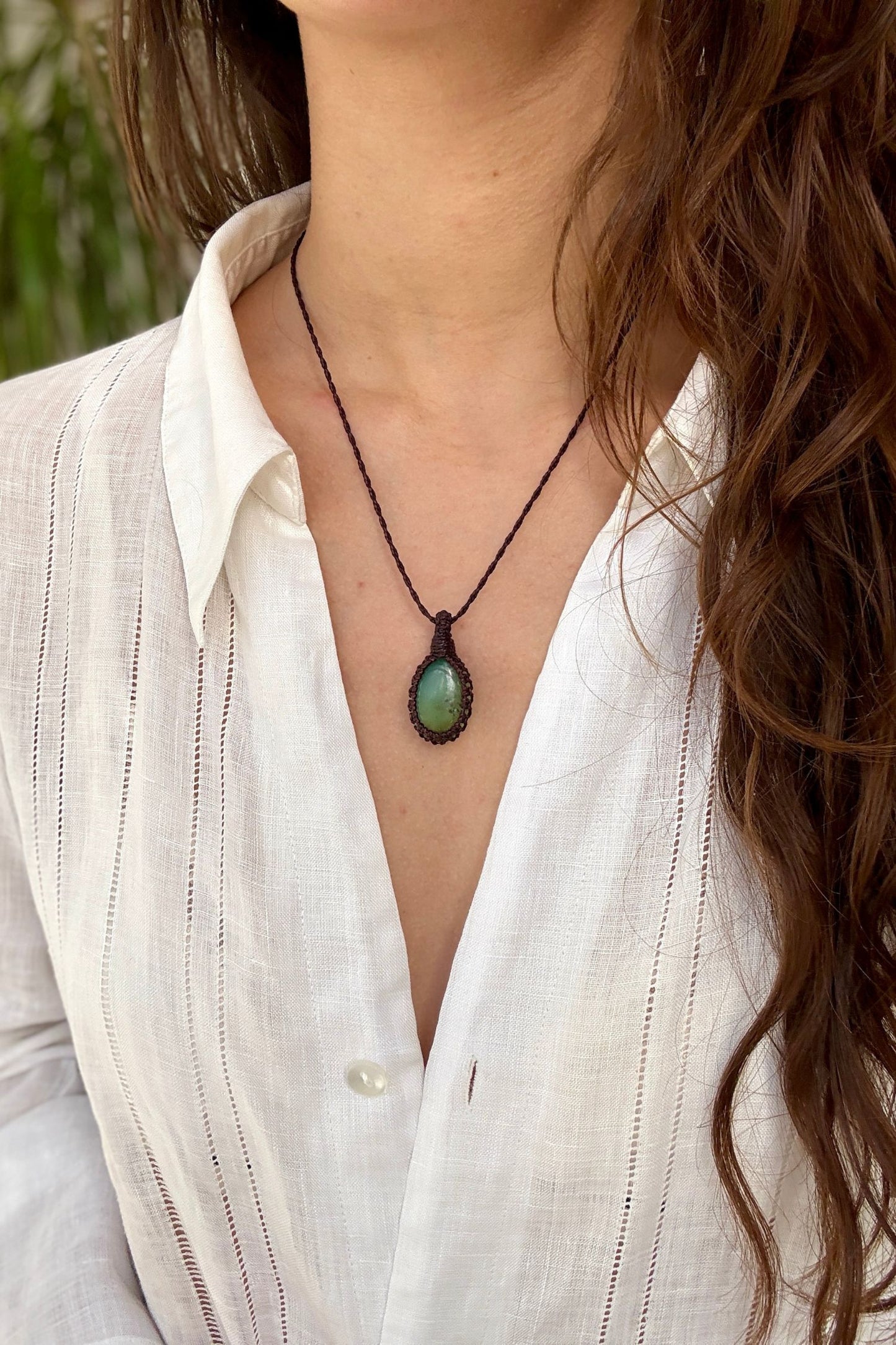Model wearing a delicate handmade Chrysoprase macrame necklace with a brown cord, perfect for everyday wear.