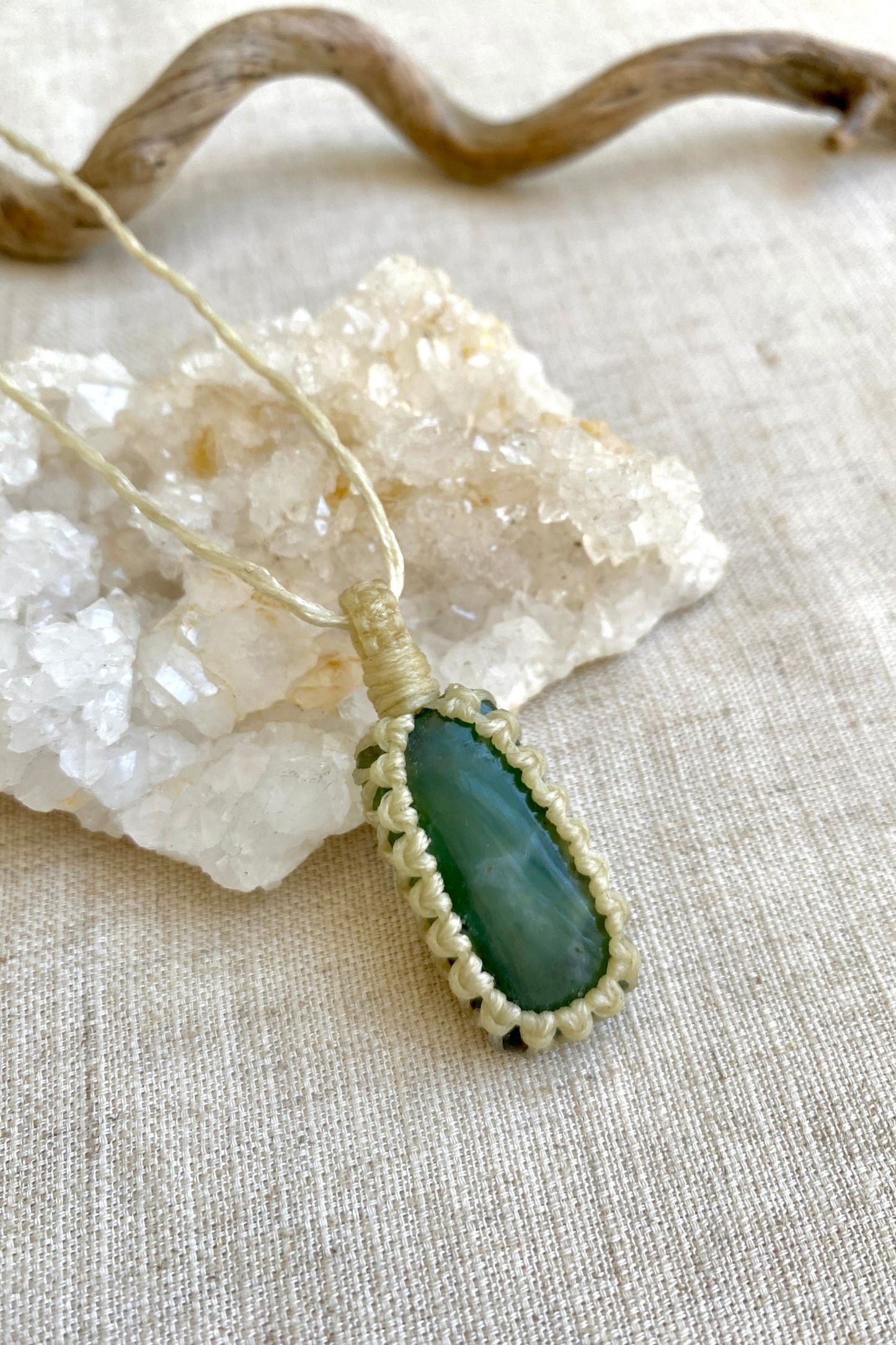 Close-up of a handmade Chrysoprase macrame necklace, emphasizing the deep forest green tones and subtle patterns of the gemstone.
