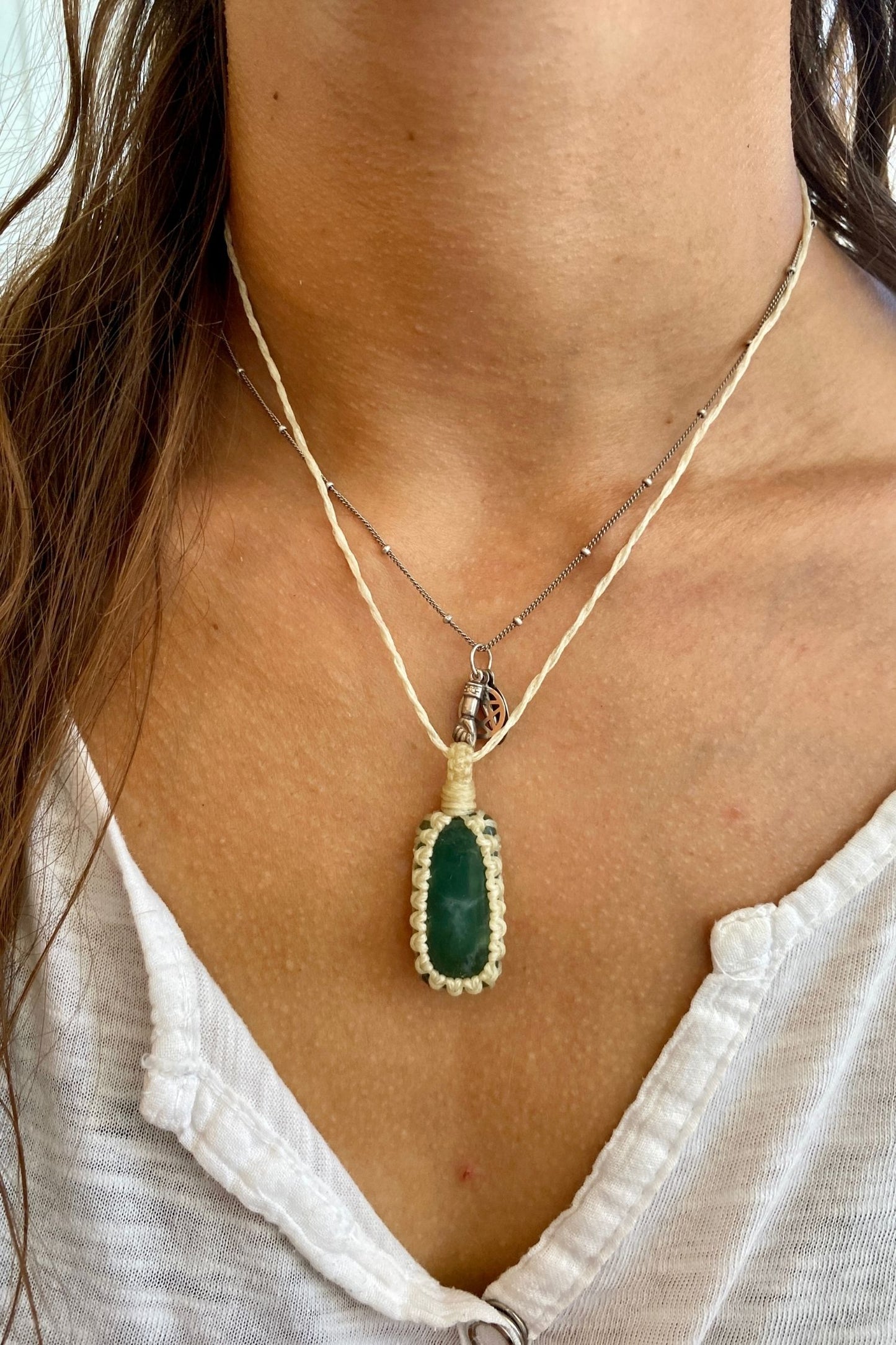 Model wearing a handmade Chrysoprase macrame necklace, featuring a vibrant green gemstone with intricate natural patterns and a simple macrame design.
