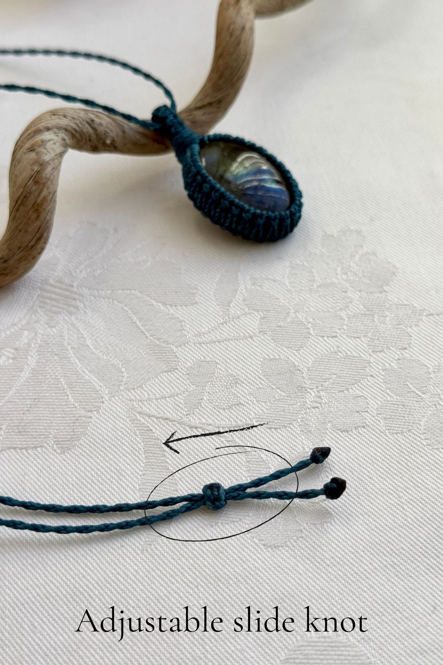 Close-up of the adjustable sliding lock on a handmade Labradorite macrame necklace, ensuring a perfect fit for all sizes.
