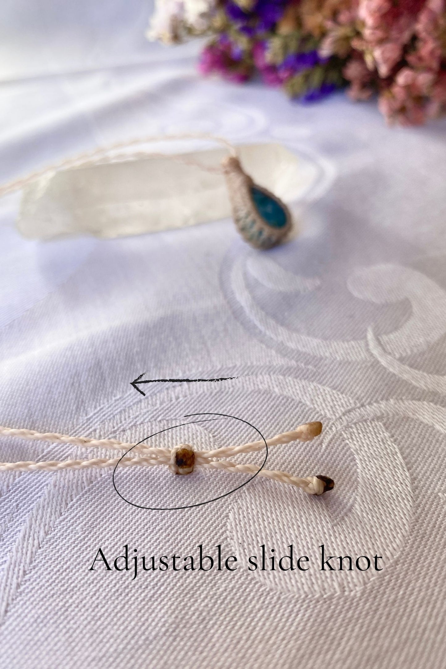 Close-up of the adjustable sliding knot on the Larimar Macrame necklace, allowing for an easy and customizable fit for any wearer.