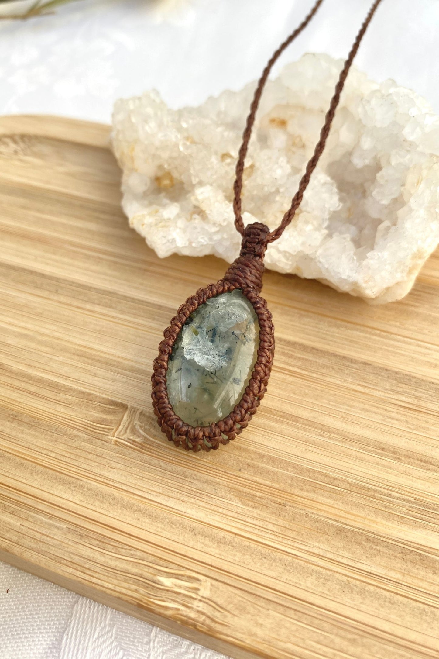 Side angle of a delicate Prehnite macrame necklace, emphasizing the soft green gemstone and fine handcrafted details.