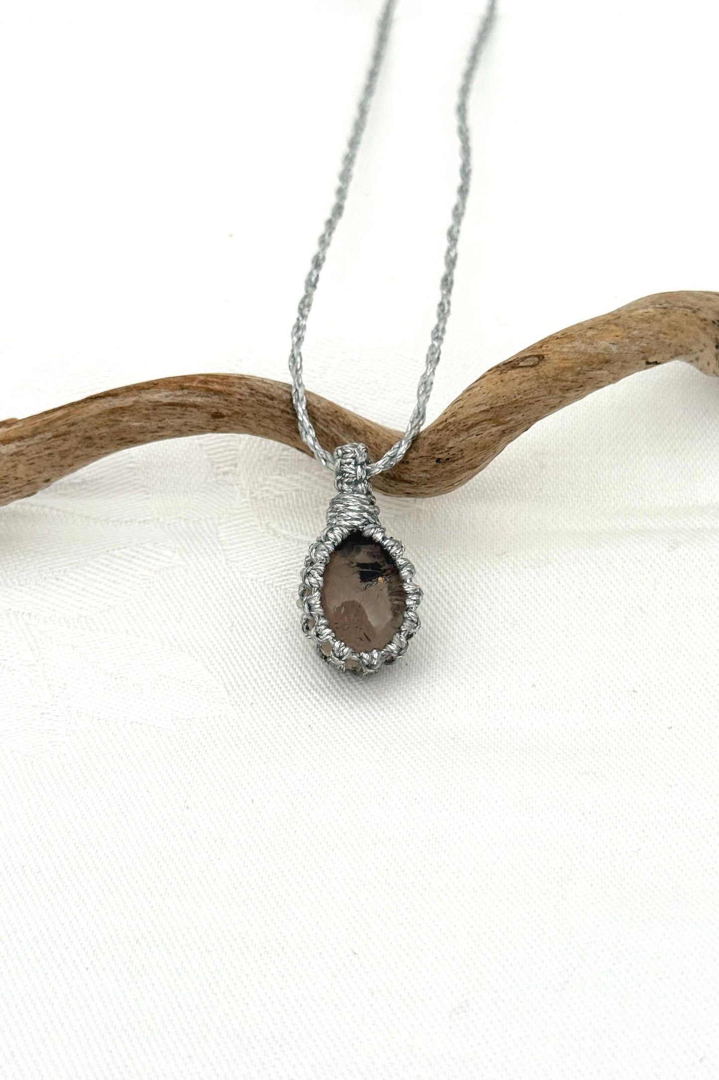 Handmade Smoky Quartz Macrame necklace featuring a high-quality gemstone, laid flat to showcase its delicate everyday-wear design from the Essence collection.