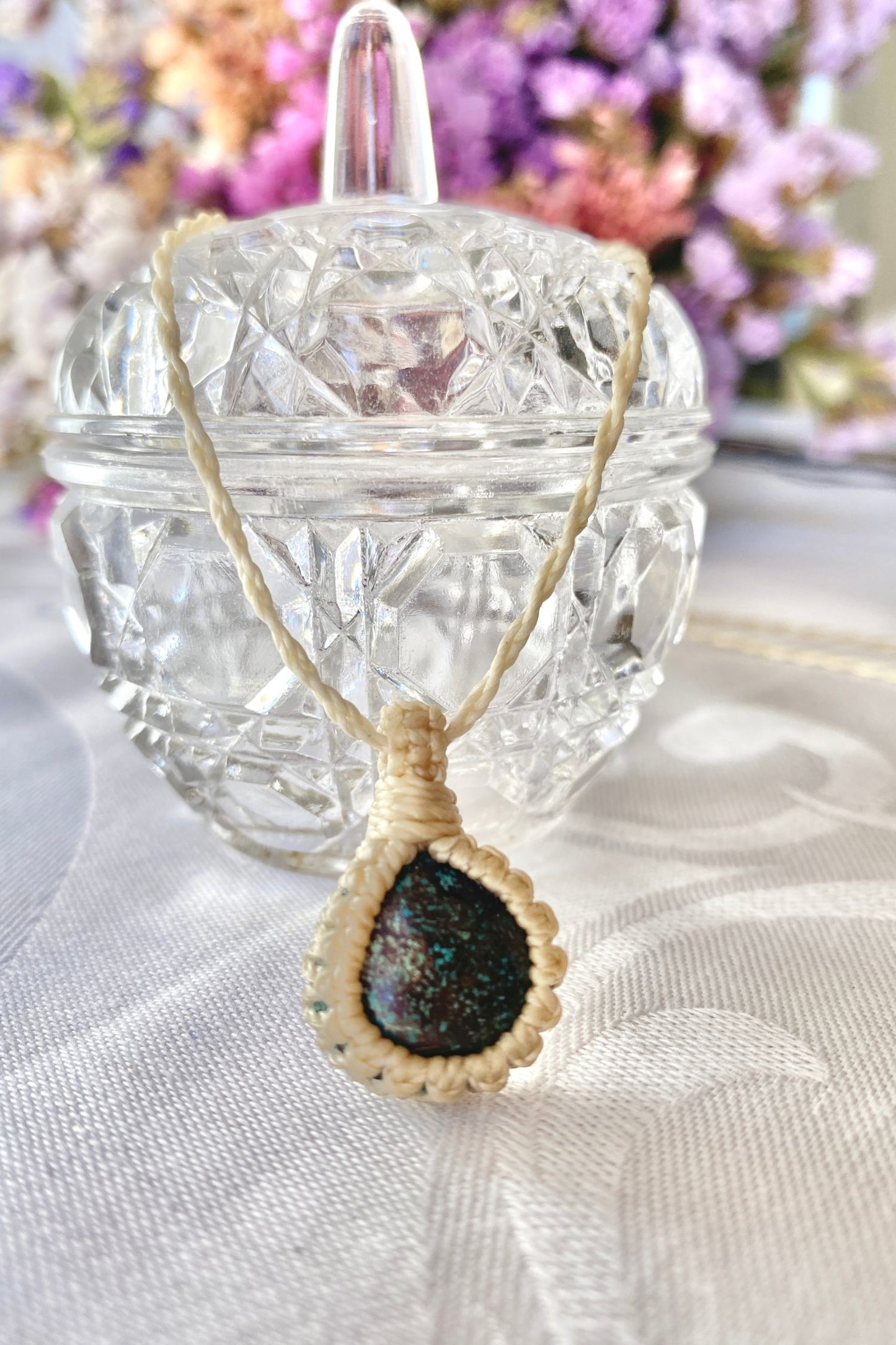Handmade Turquoise Macrame necklace displayed standing, highlighting the minimalist macrame design and the natural beauty of the natural gemstone.