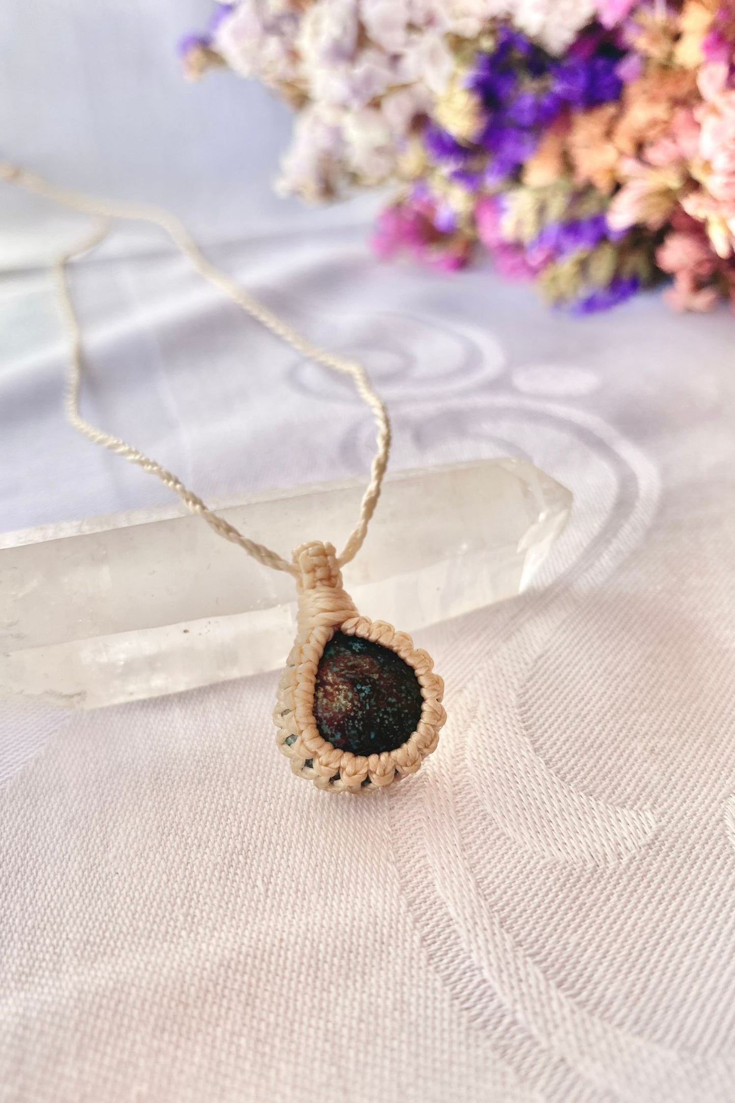 Side angle view of the Turquoise Macrame necklace, showing the fine macrame details and the unique gemstone centerpiece.