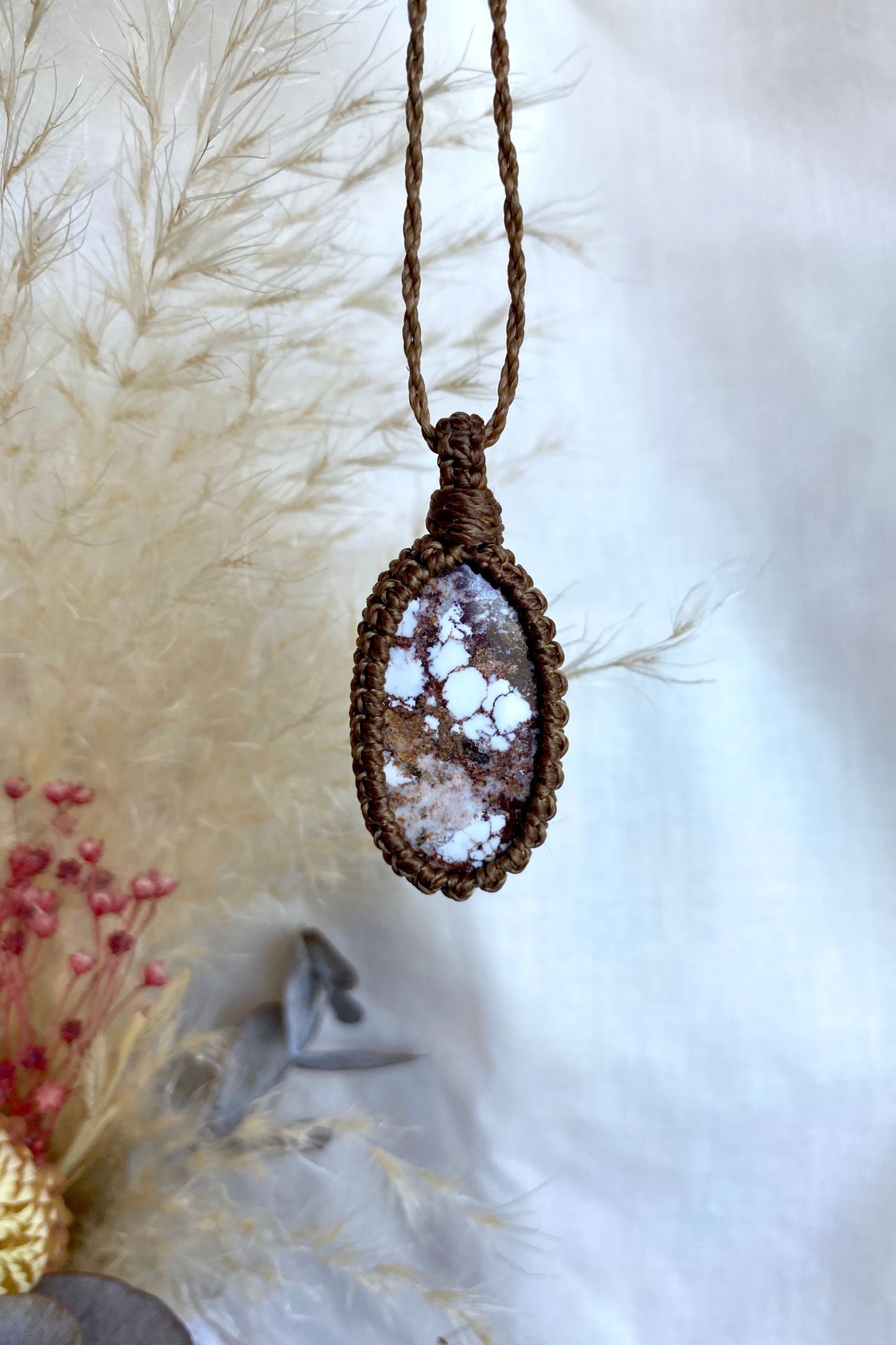 Handmade Wild Horse Magnesite macrame necklace displayed on a clean background, highlighting the gemstone’s intricate patterns and warm color variations.
