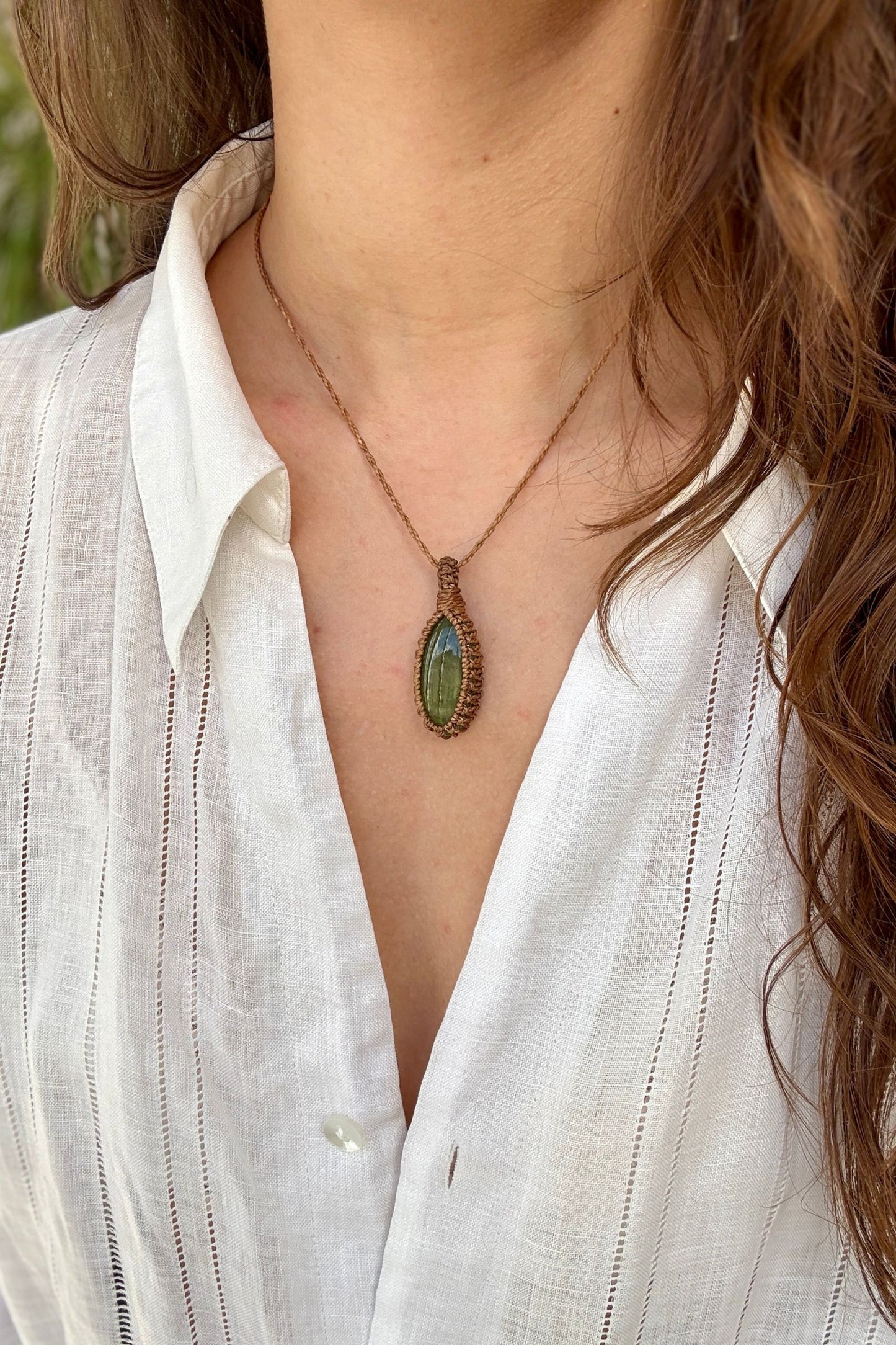 Model wearing a delicate handmade Vesuvianite macrame necklace with a golden brown cord, perfect for everyday wear.
