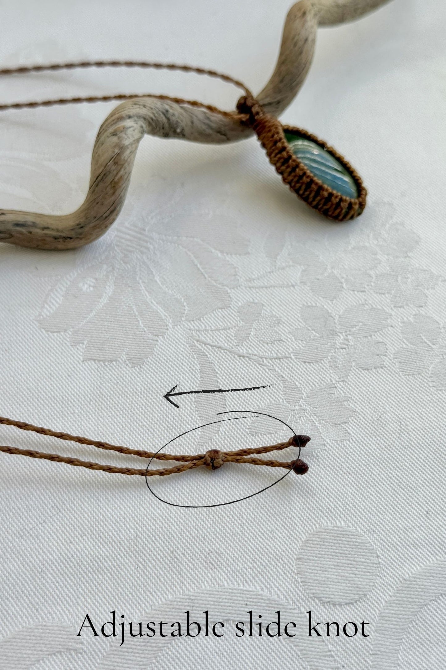 Close-up of the adjustable sliding lock on a handmade Vesuvianite macrame necklace, ensuring a perfect fit for all sizes.