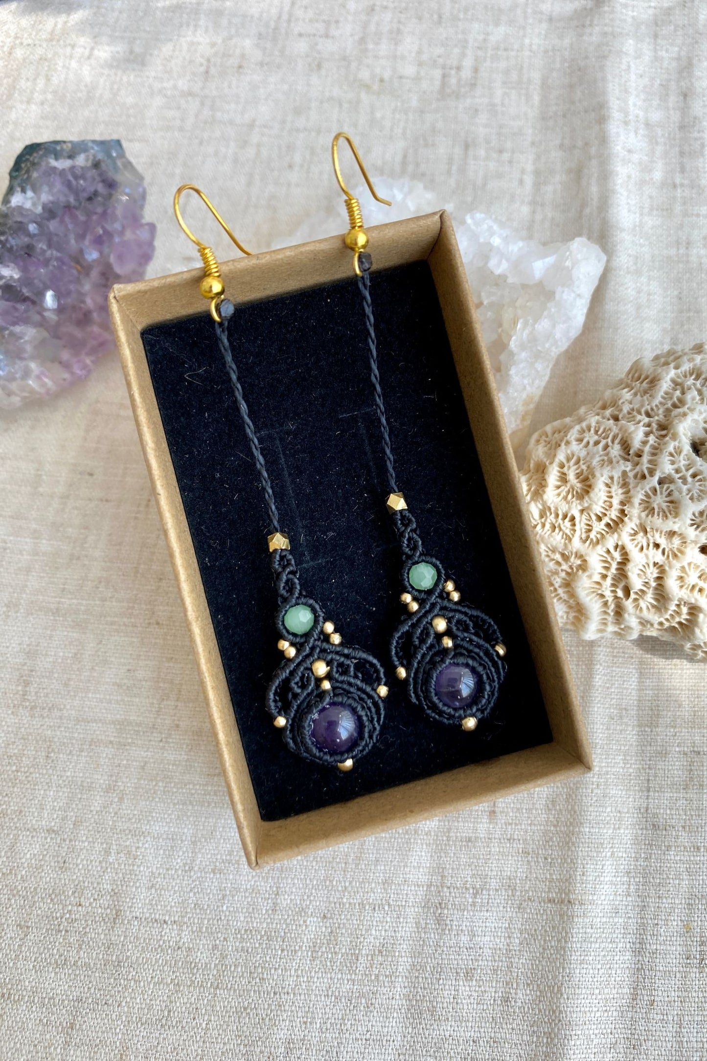 Handmade macrame earrings with amethyst and prehnite gemstones, displayed in a box to highlight the contrast of the gemstones and intricate design.