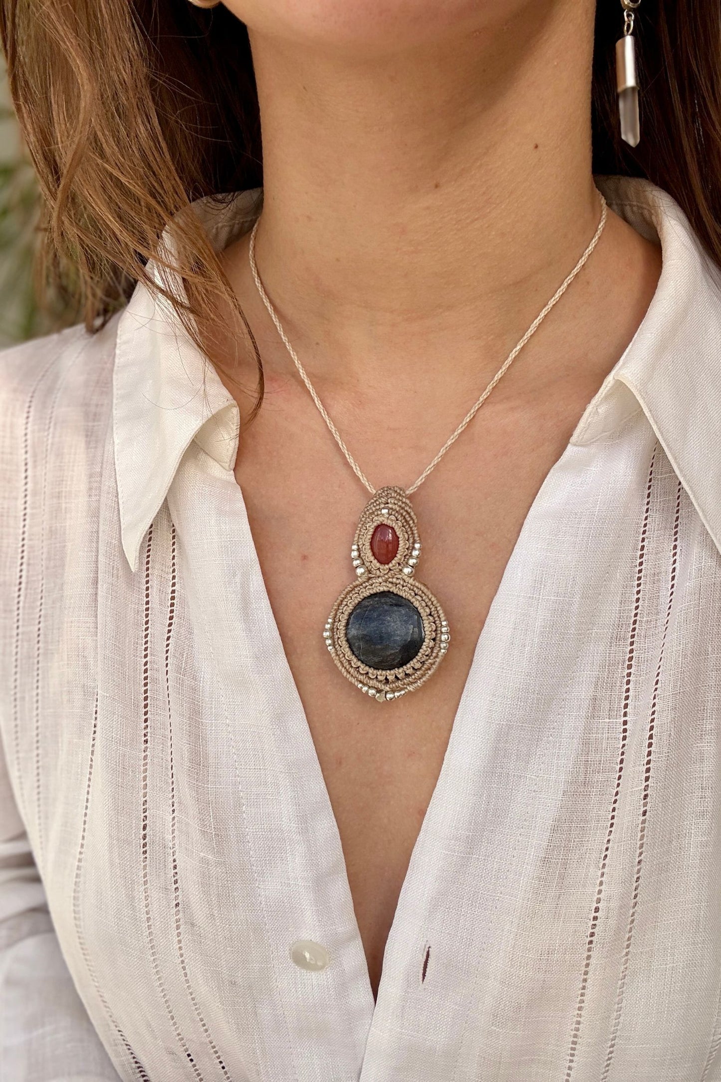 Carnelian and Silver Sheen Obsidian macrame necklace worn by a model. Showcasing the unique handmade design and how it looks when worn.