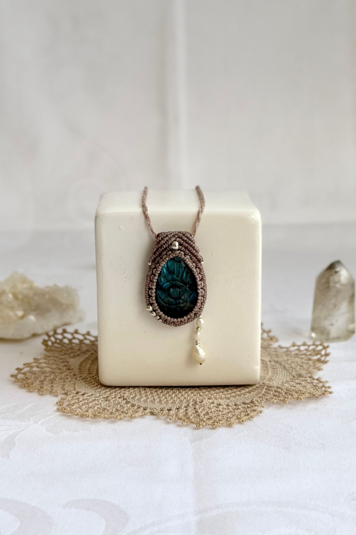 Artisan Labradorite protective eye necklace, shown from another angle to capture gemstone hues and macrame thread work.