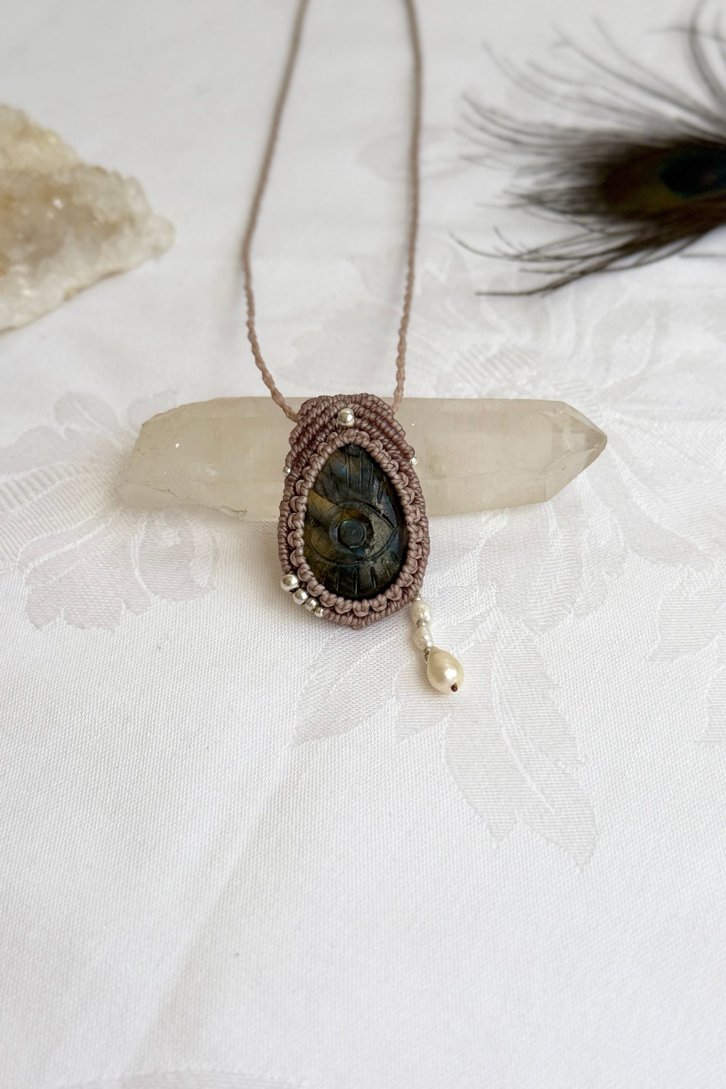 Handmade macrame necklace with Labradorite protective eye pendant, displayed flat to reveal the fresh Water Pearl accents.