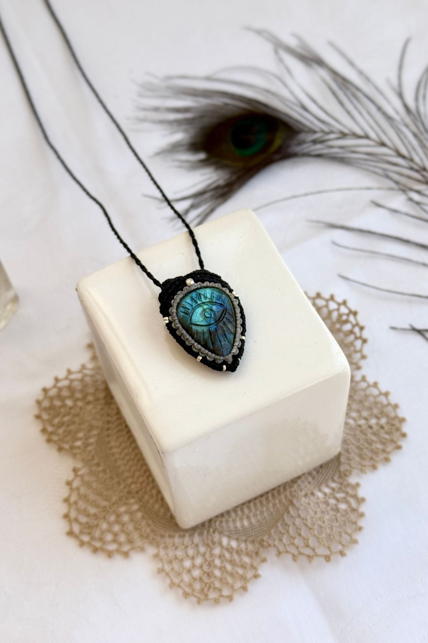 Artisan Labradorite protective eye necklace, shown from another angle to capture gemstone hues and macrame thread work.