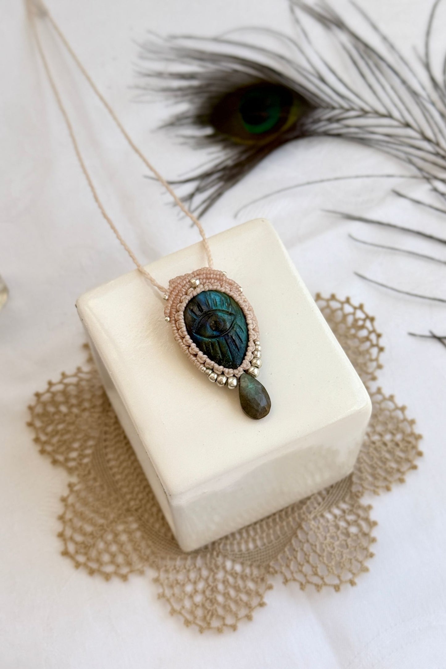 Artisan Labradorite protective eye necklace, shown from another angle to capture gemstone hues and macrame thread work.
