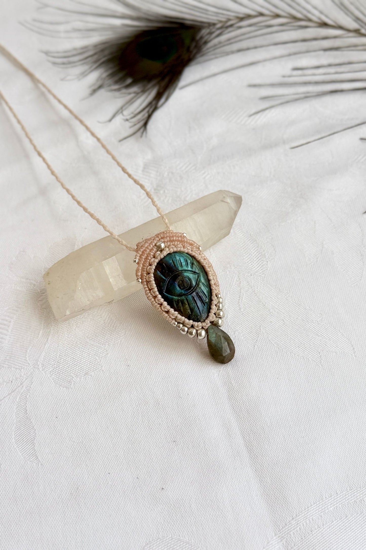 Artisan Labradorite protective eye necklace, shown from another angle to capture gemstone hues faceted dropping tear detail.