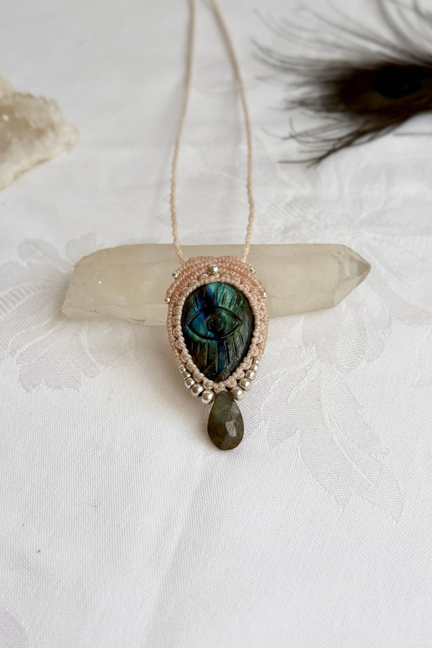 Handmade macrame necklace with Labradorite protective eye pendant, displayed flat to reveal gemstone’s natural labradorescence.