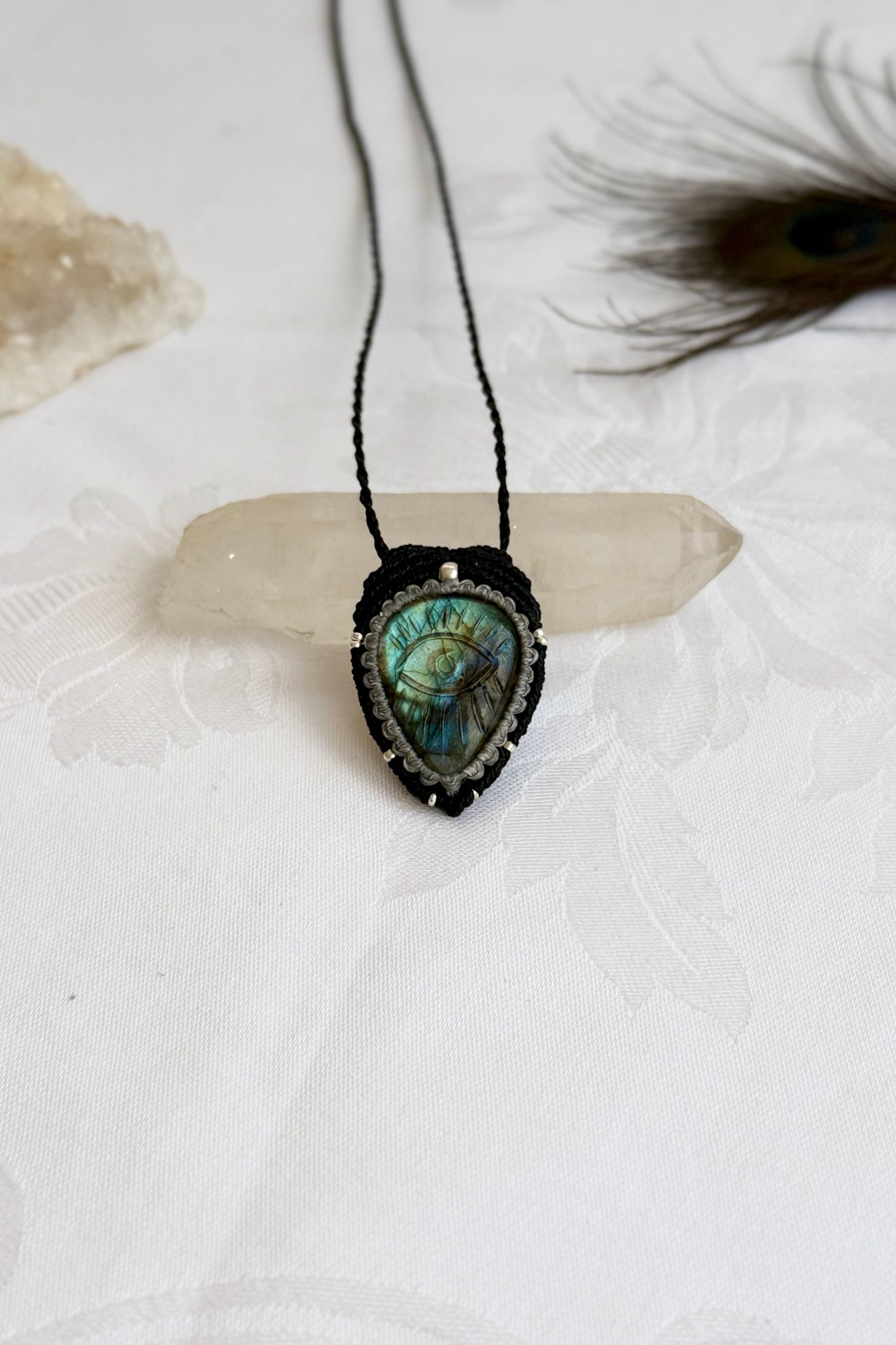 Handmade macrame necklace with Labradorite protective eye pendant, displayed flat to reveal gemstone’s natural labradorescence.