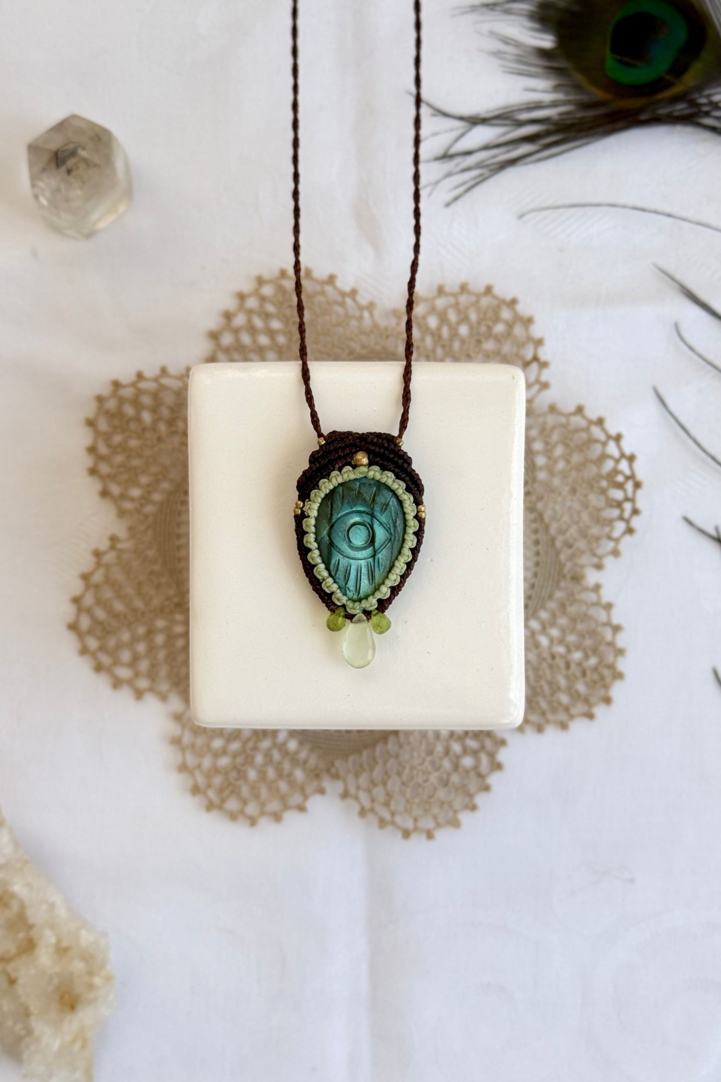 Artisan Labradorite protective eye necklace, shown from another angle to capture gemstone hues and macrame thread work.