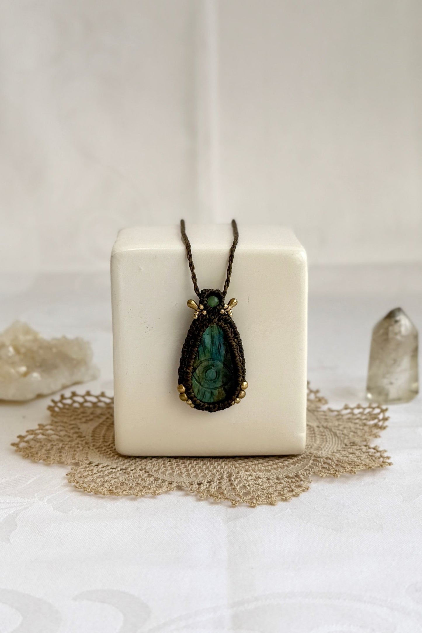Artisan Labradorite protective eye necklace, shown from another angle to capture gemstone hues and macrame thread work.