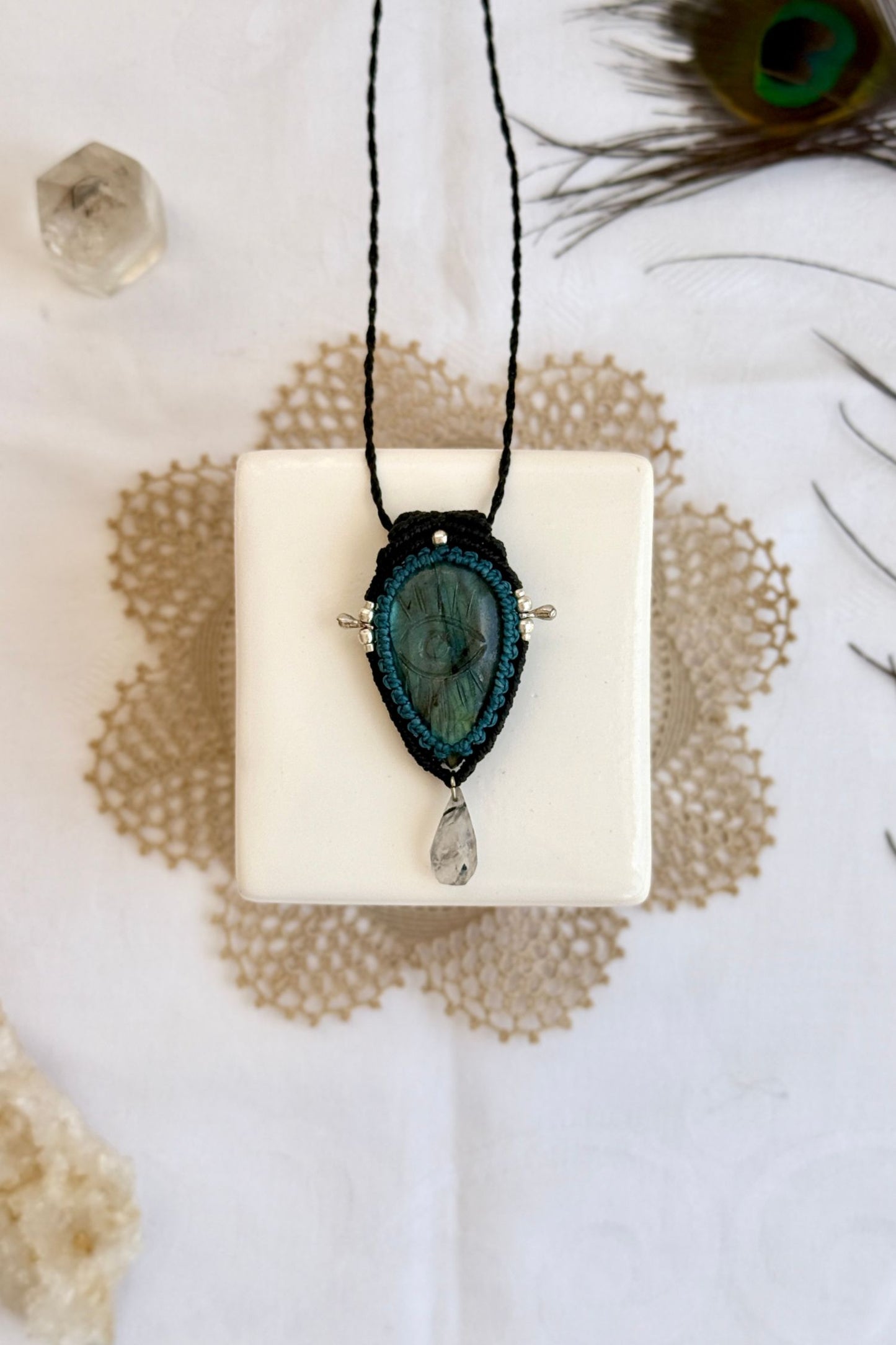 Artisan Labradorite protective eye necklace, shown from another angle to capture gemstone hues and macrame thread work.