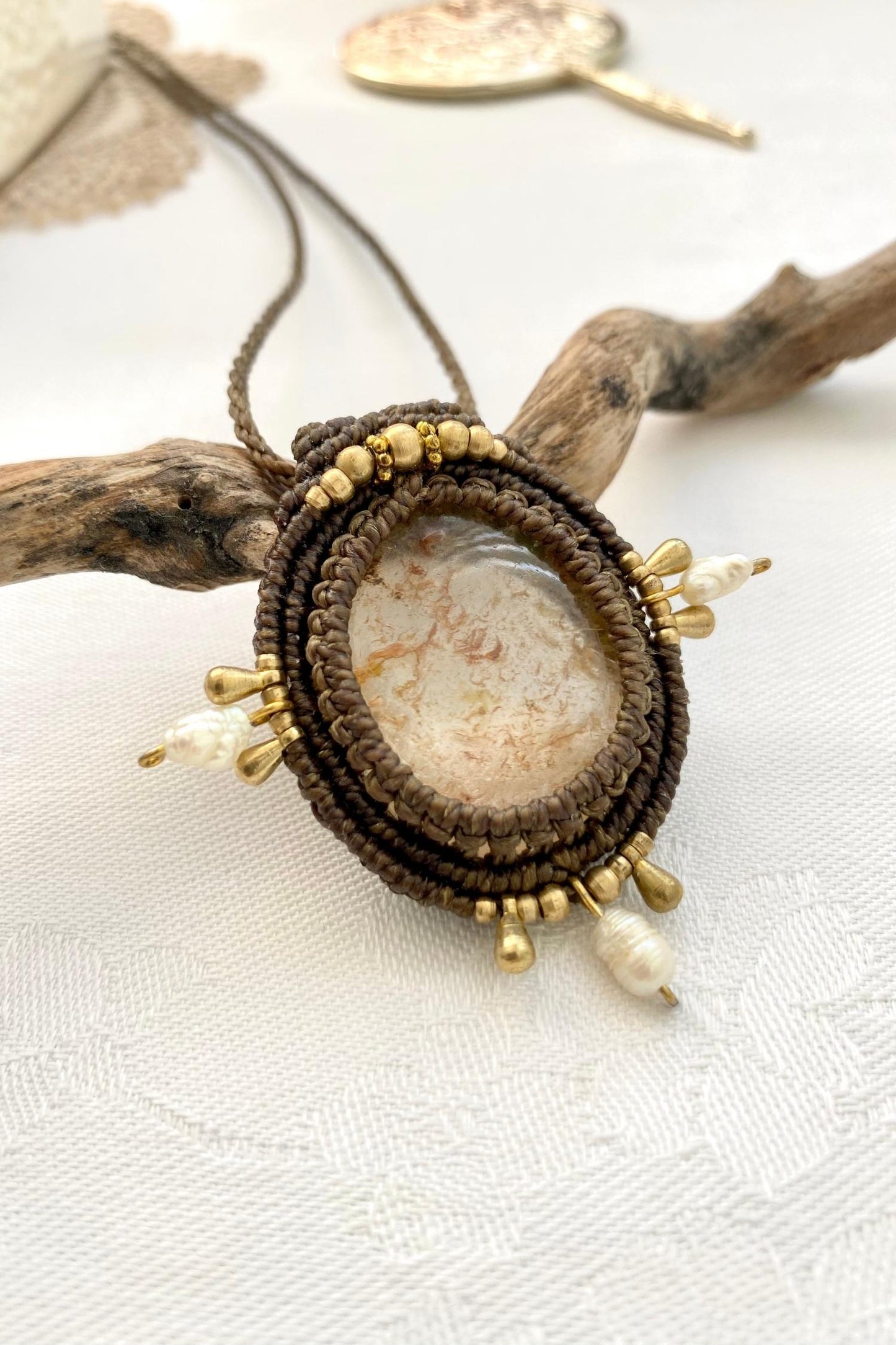 Side angle of the handcrafted macrame necklace, highlighting the detailed craftsmanship and the rich colors of Lodolite gemstone and Pearls.