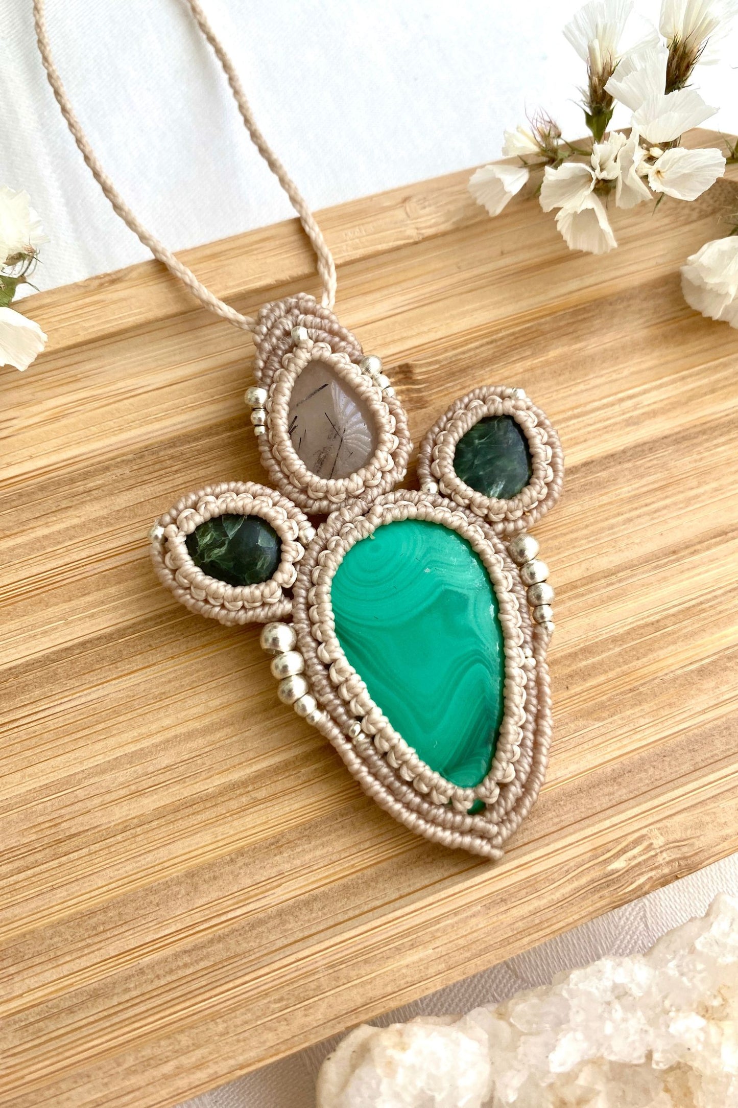 A close-up of the handmade gemstone necklace, showcasing the natural beauty of Malachite, Seraphinite and Tourmaline Quartz in an exclusive, one-of-a-kind design.