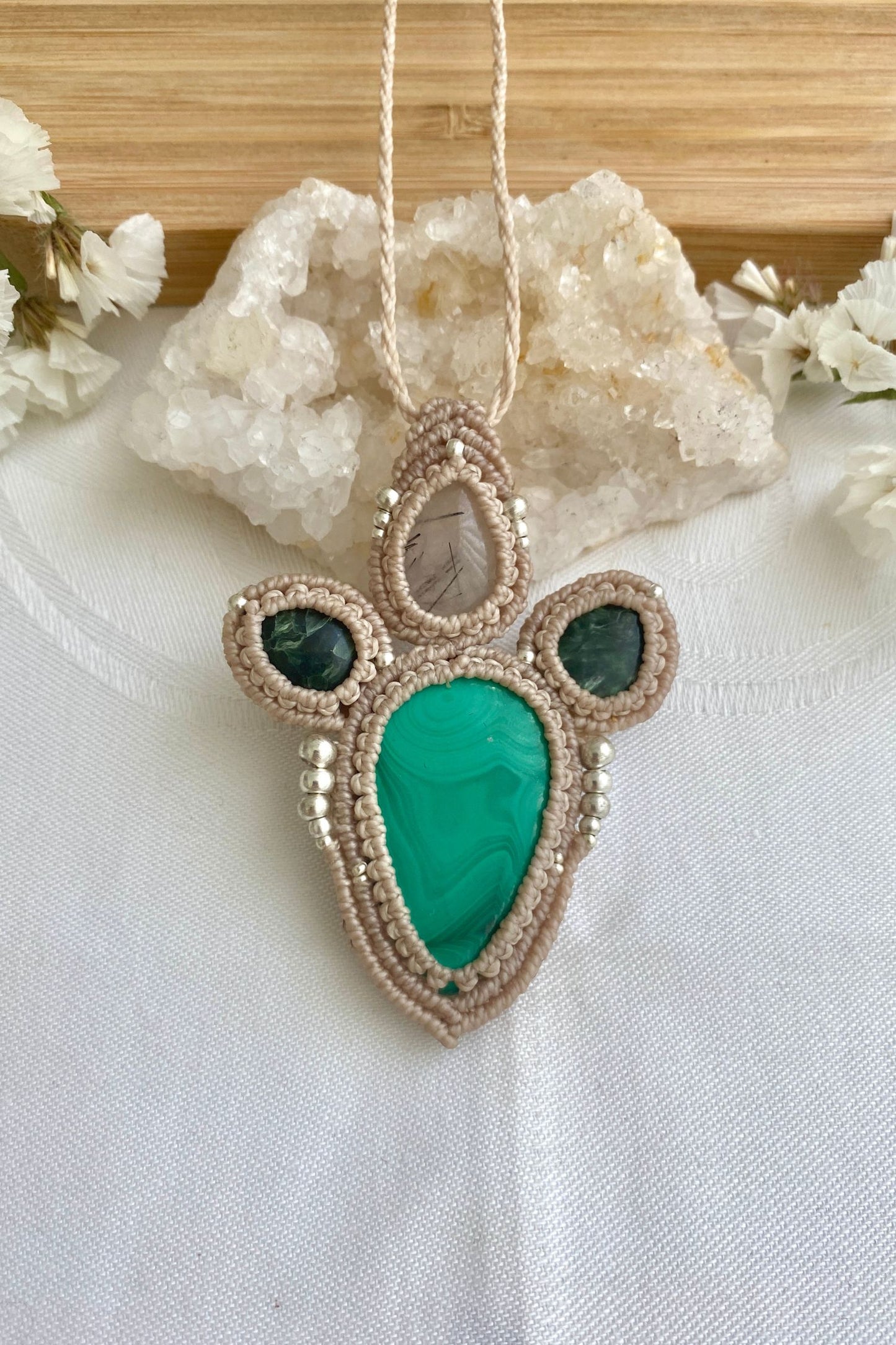 Detailed view of the handmade necklace, highlighting the raw textures of natural Tourmaline Quartz, and Malachite gemstones in a distinctive, statement-making design.