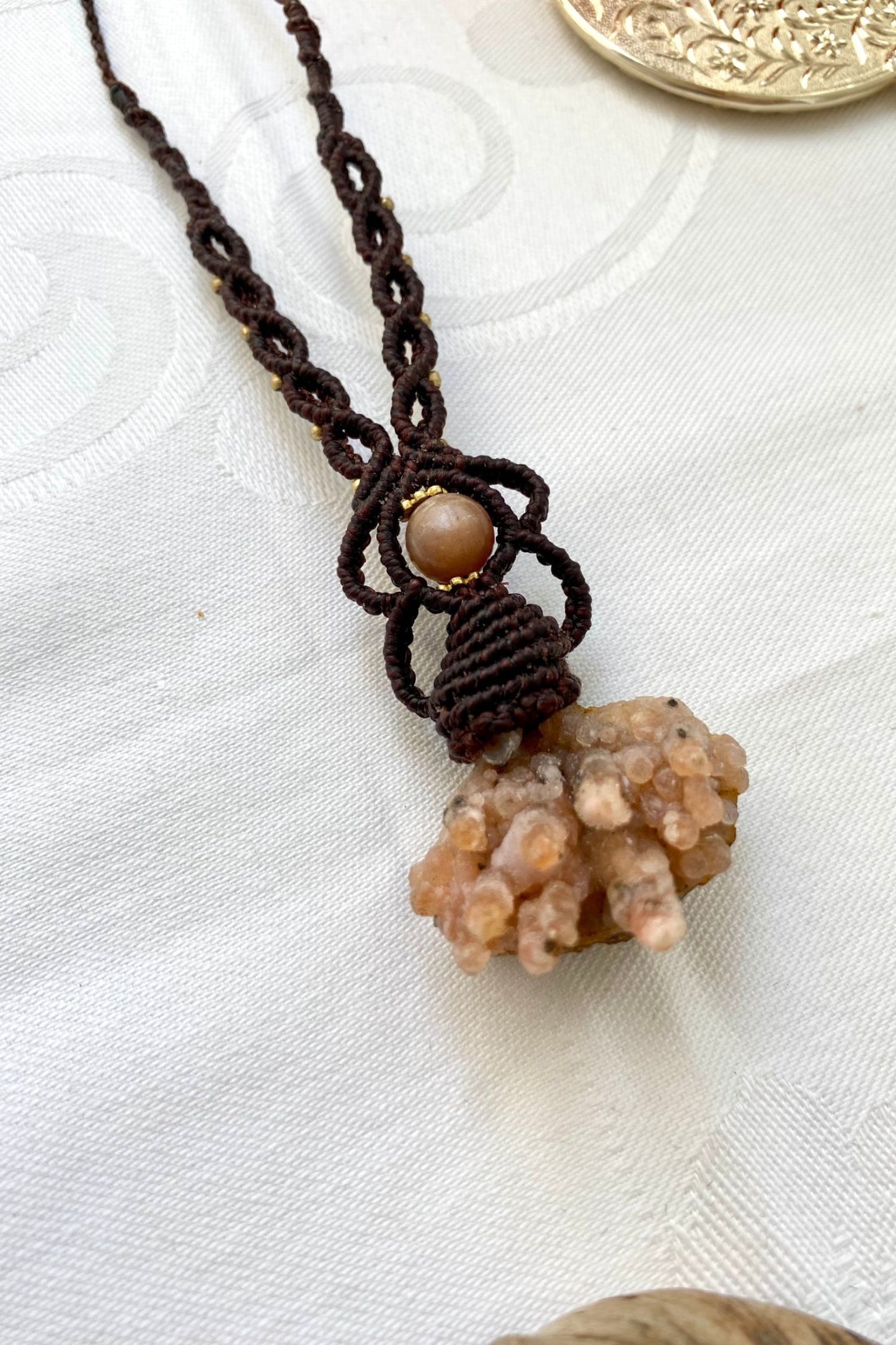 Side angle of the handcrafted macrame necklace, highlighting the detailed craftsmanship and the rich colors of Raw Chalcedony and Peach Moonstone gemstones.